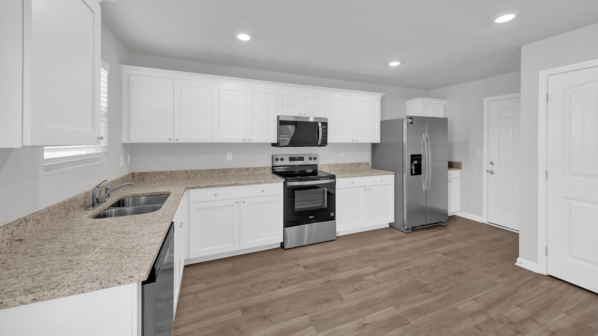 Spacious kitchen area with beautiful granite countertops