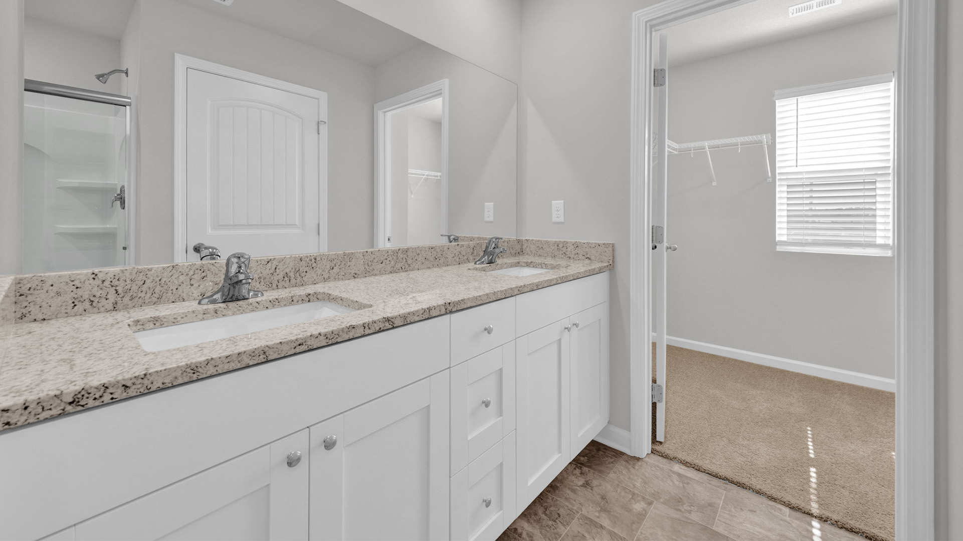 En suite primary bathroom with a dual vanity