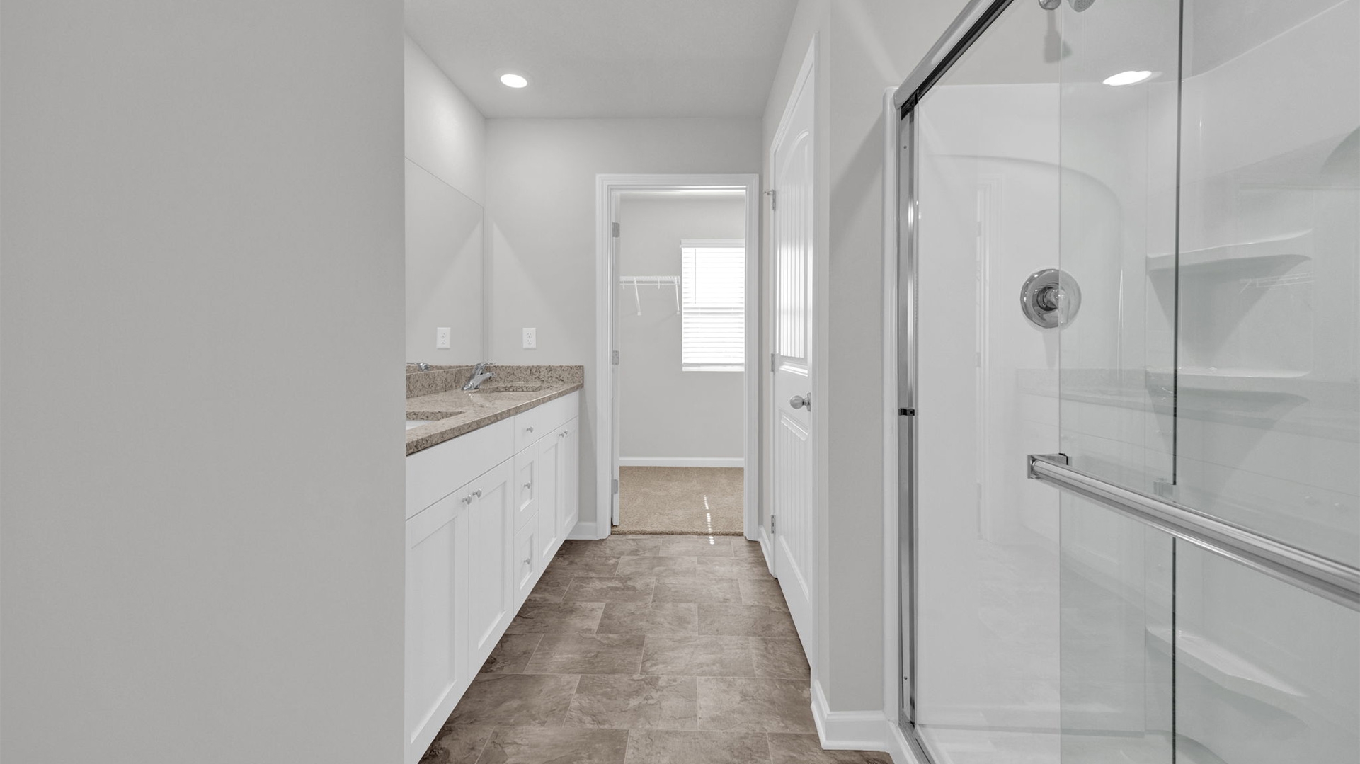 Glass enclosed shower in the primary bathroom