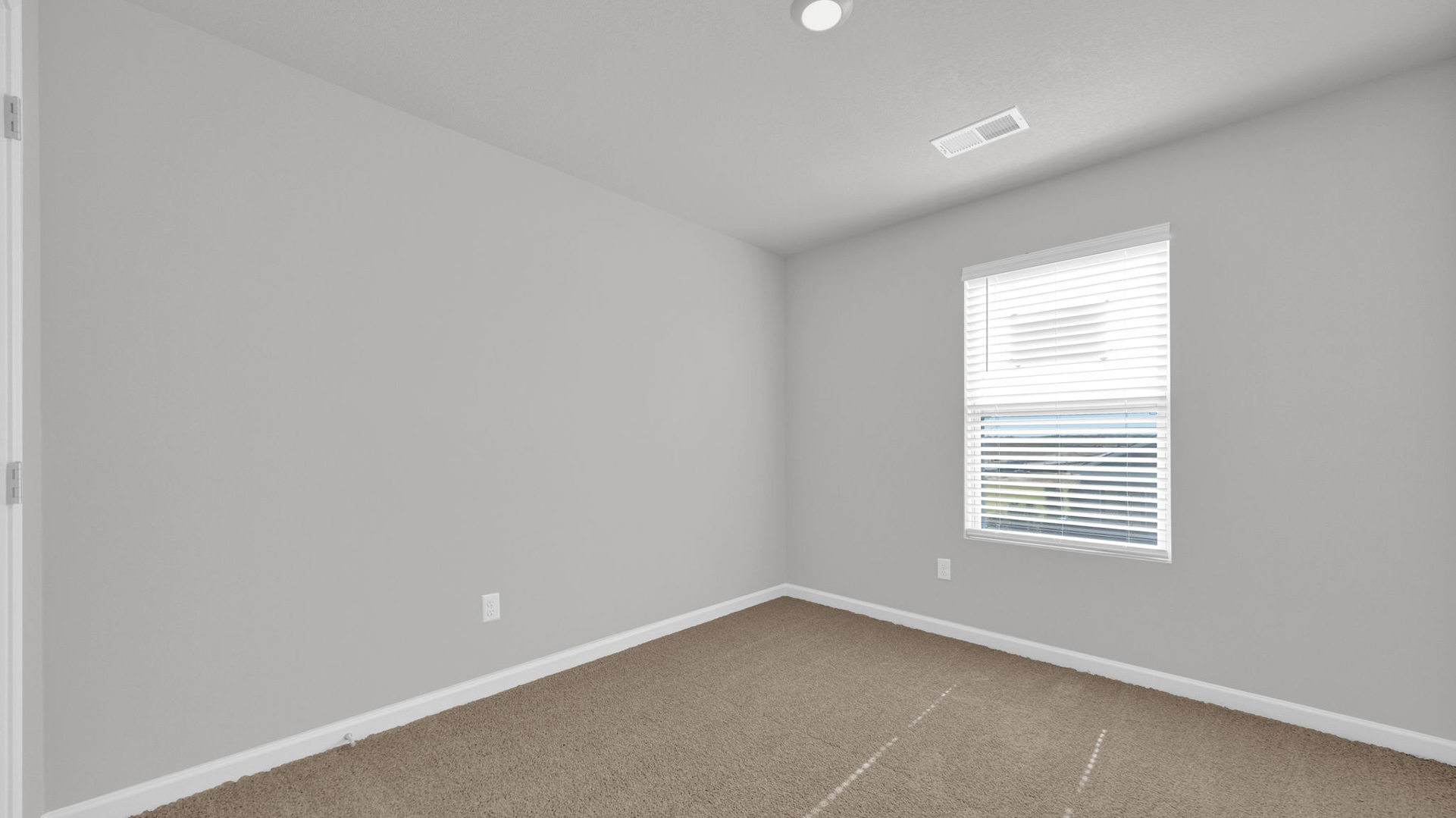 Second bedroom on the second floor with carpet flooring