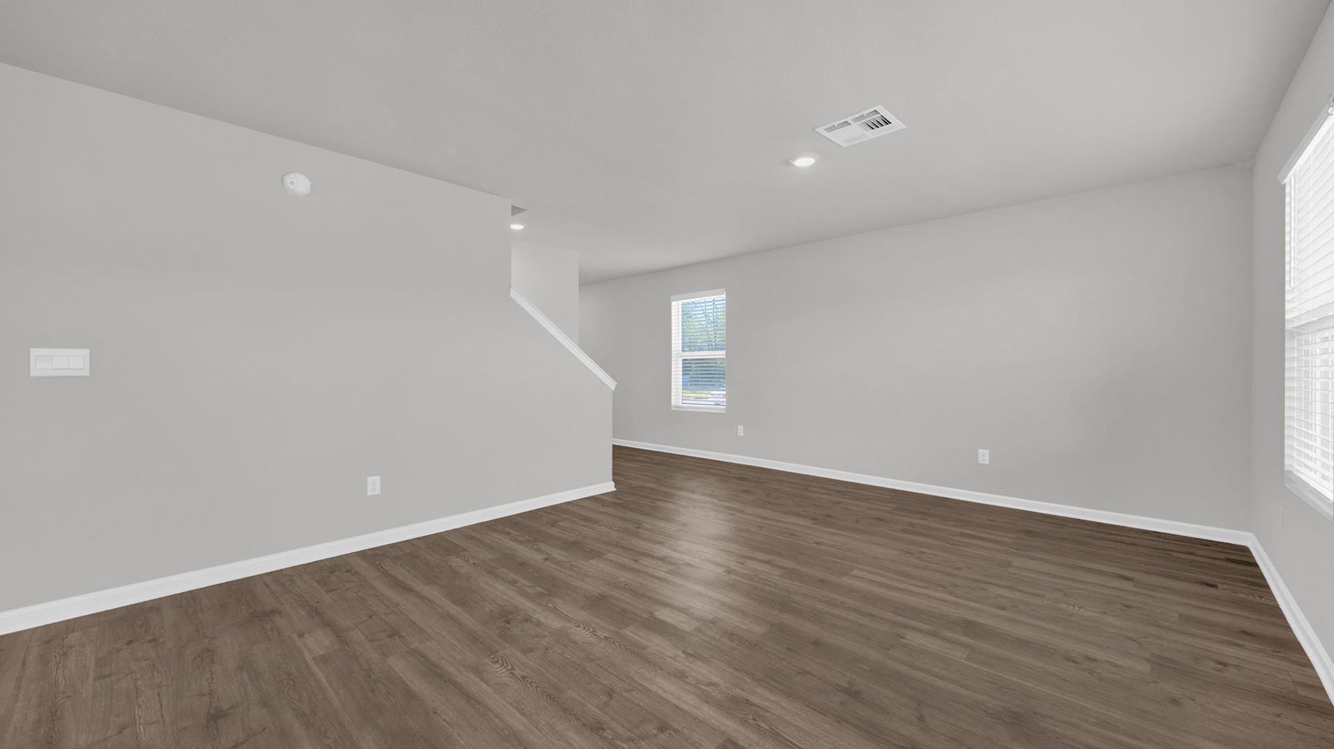 Living room with neutral paint and vinyl flooring