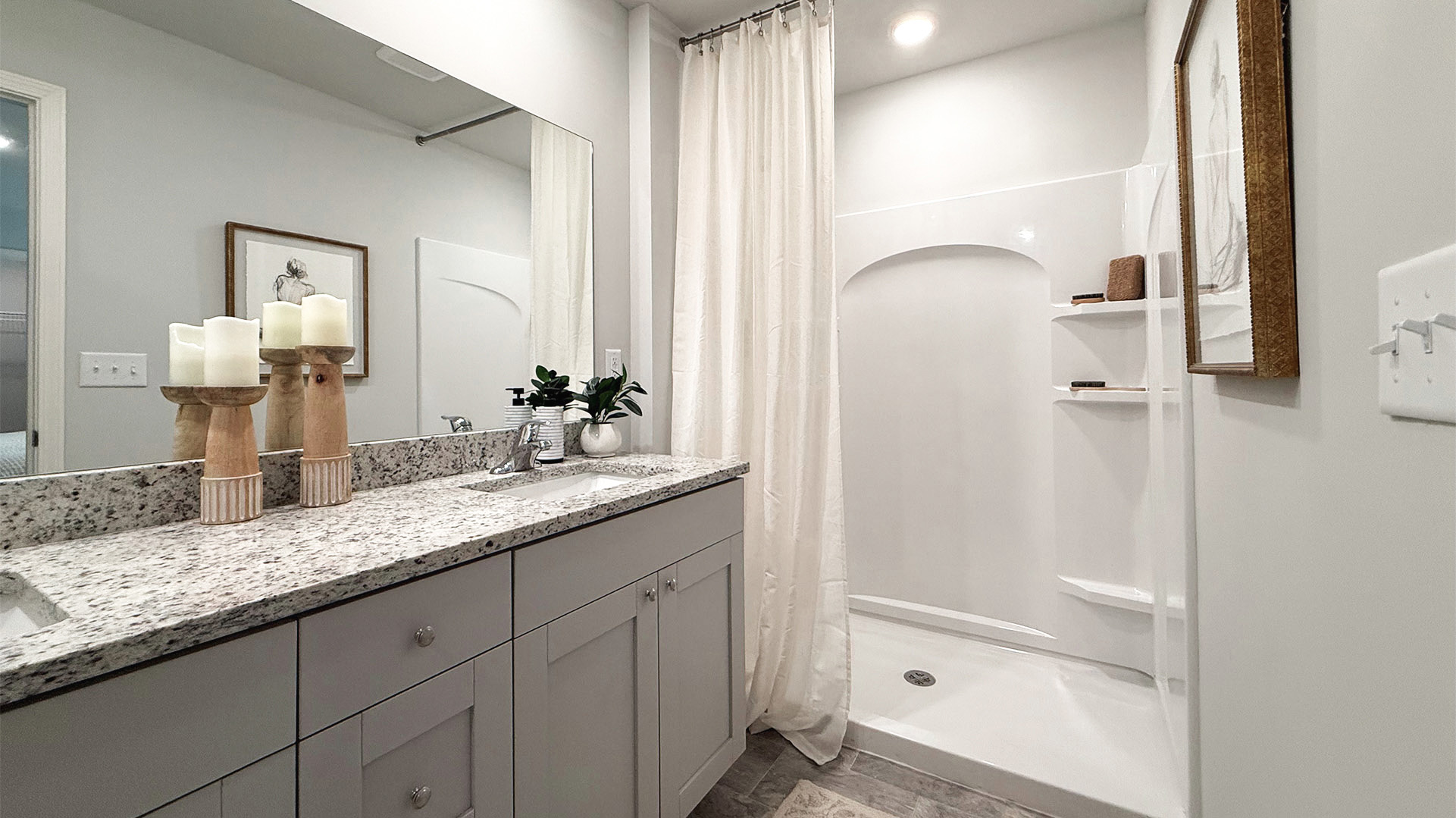 Primary en-suite with a granite countertop vanity