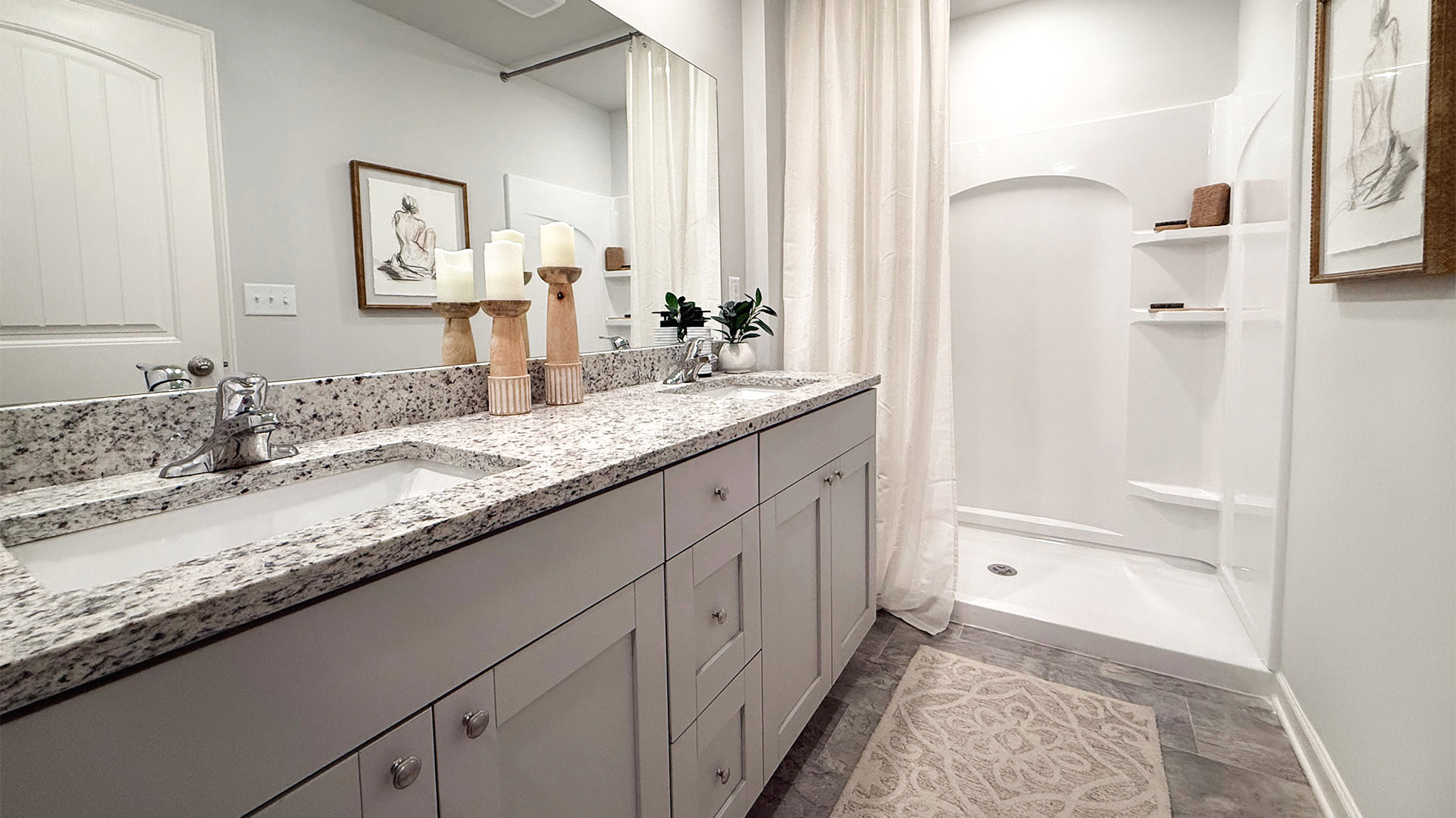 Primary en suite bathroom with a dual vanity and a walk in shower