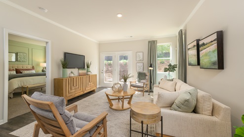 Spacious living room with a large double window overlooking the backyard