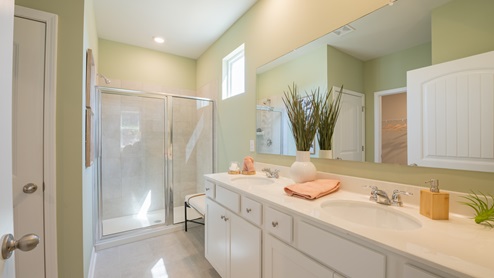 EN suite primary bathroom with a single vanity and two sinks