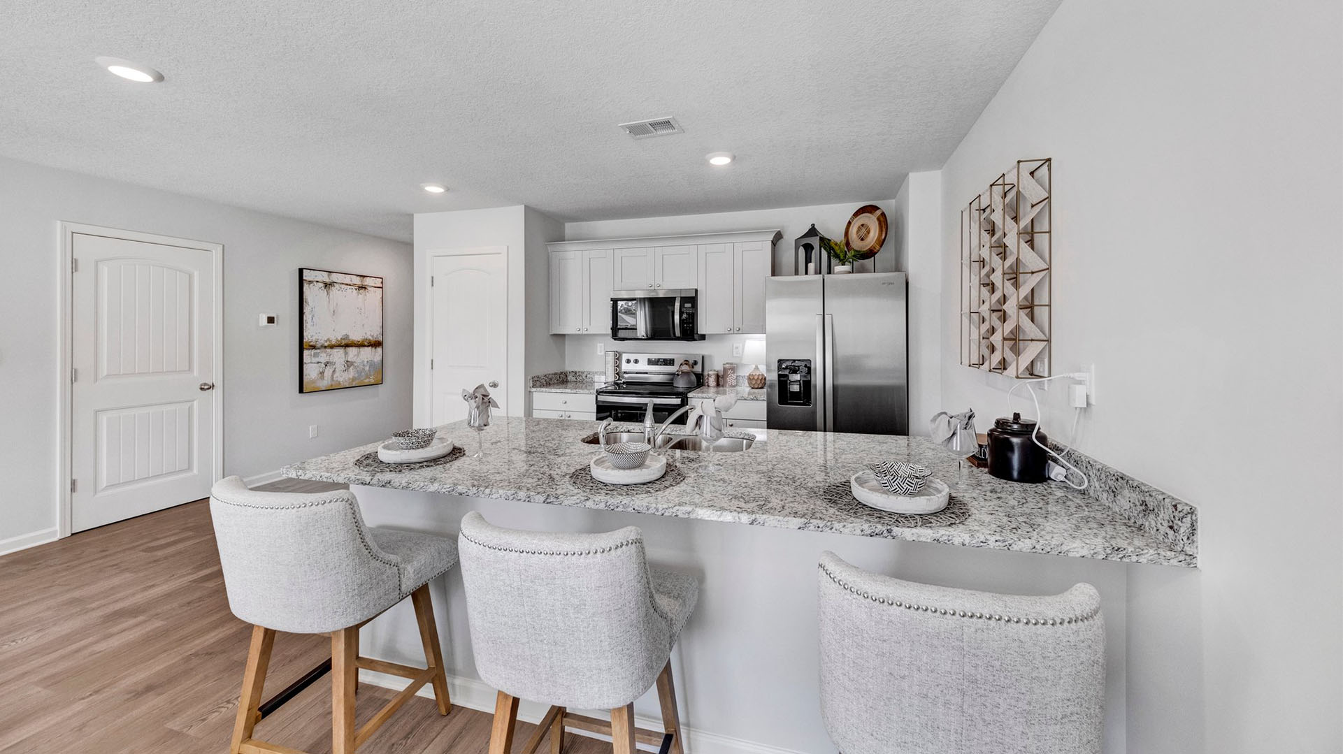 Kitchen area opens up at the end of entry hall