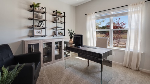 secondary bedroom shown as home office with large window overlooking the front of the home