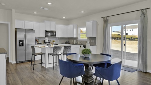 Informal dining and kitchen with sliding glass doors to patio