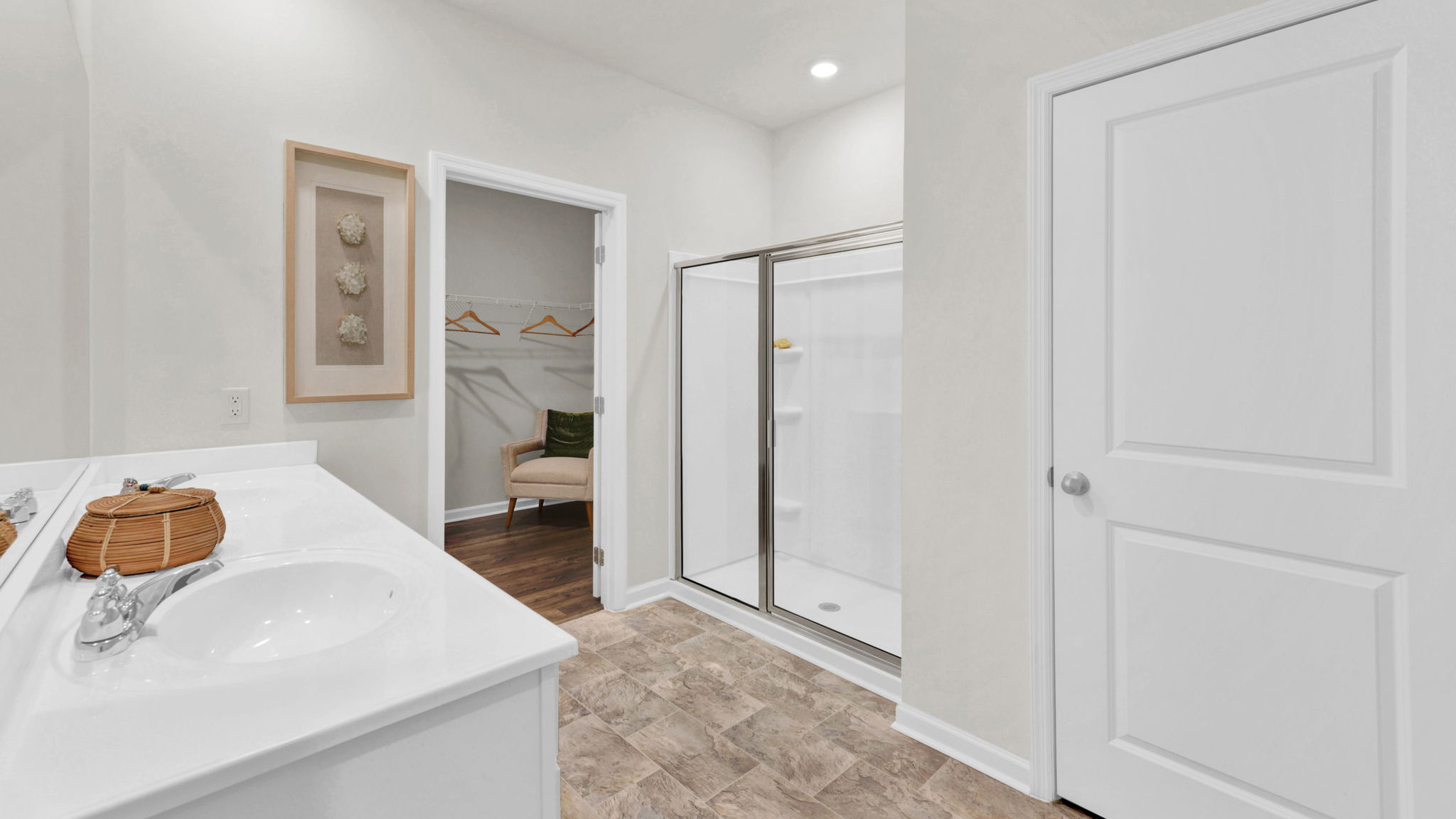 primary bathroom with double vanity and walk-in shower