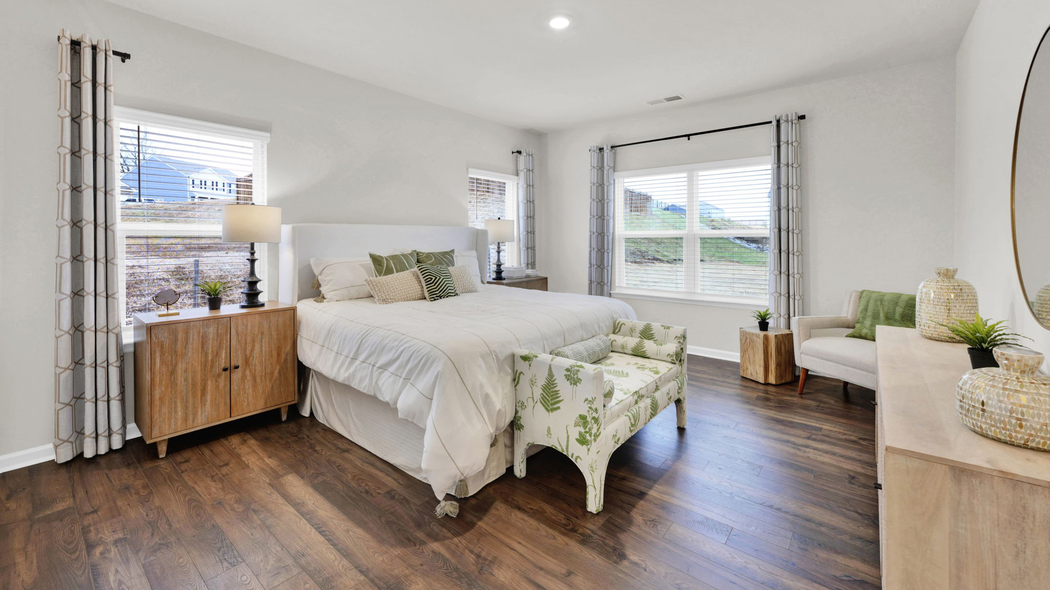 primay bedroom with two single windows and one double window