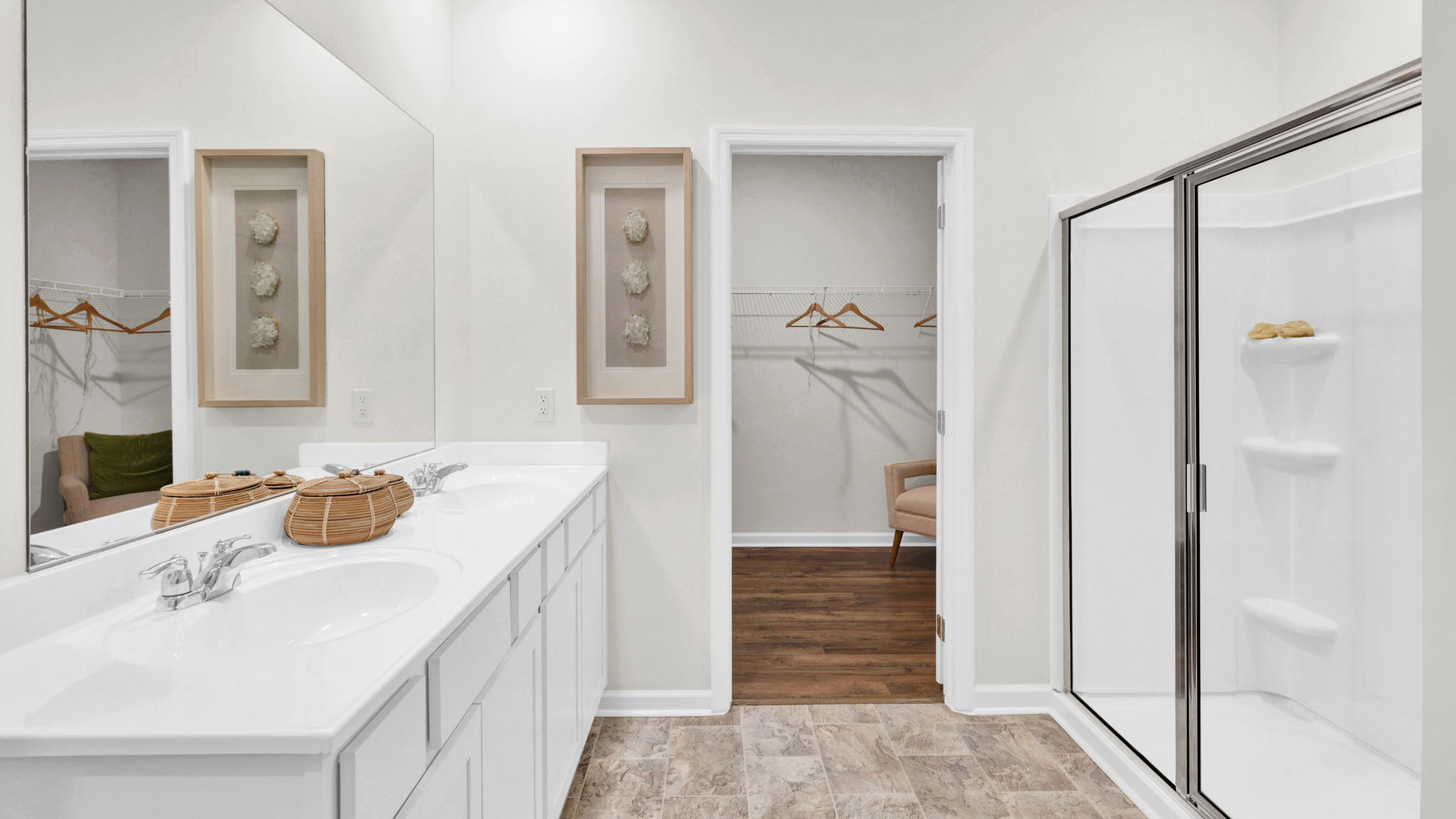 primary bathroom with double vanity and walk-in shower
