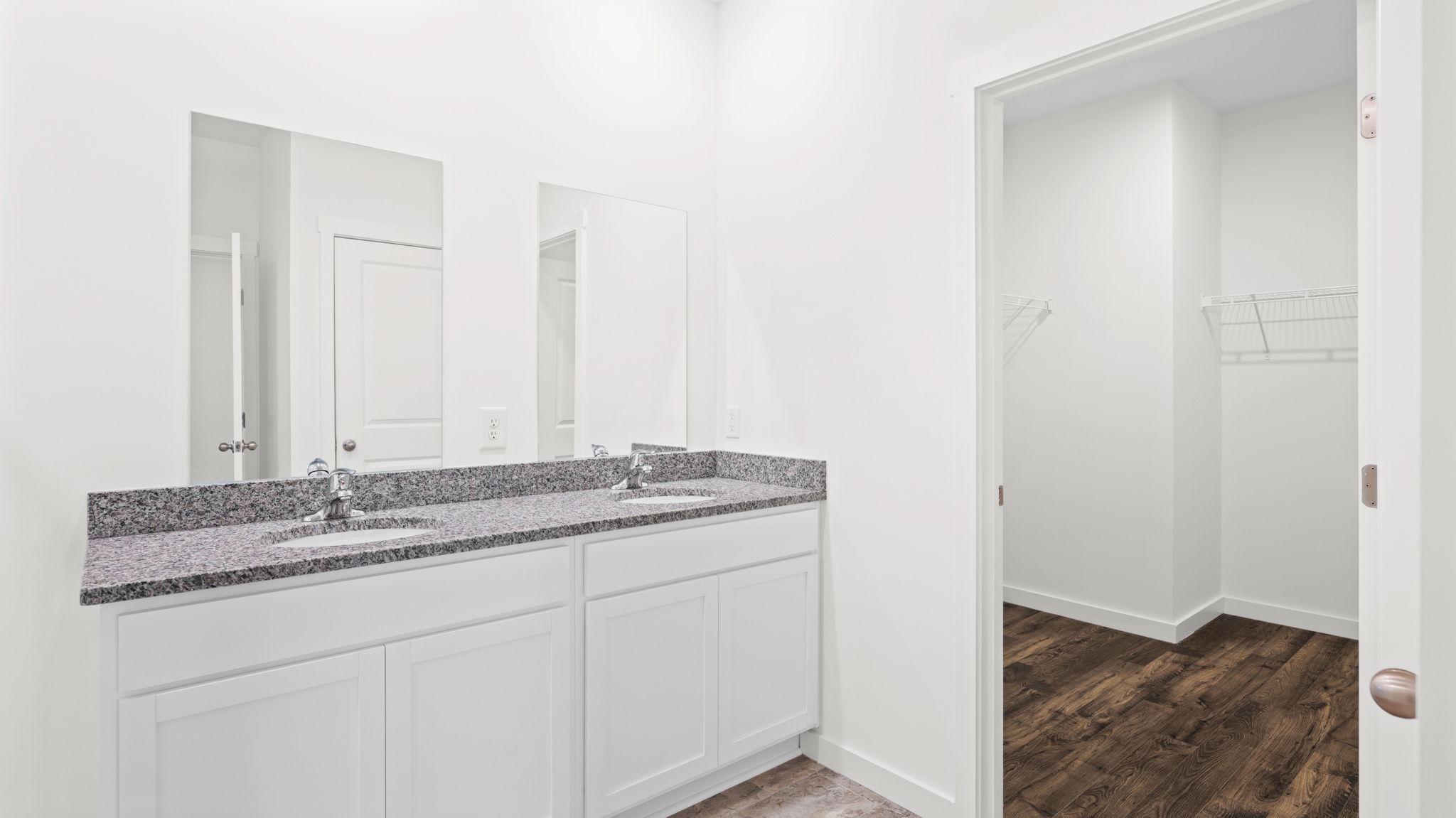 primary bathroom with double vanity and walk-in shower