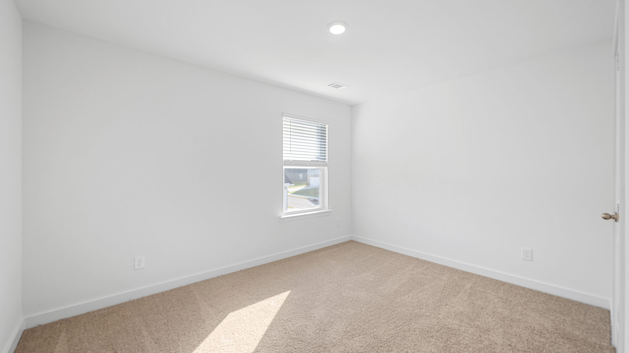 bedroom with single window and walk-in closet