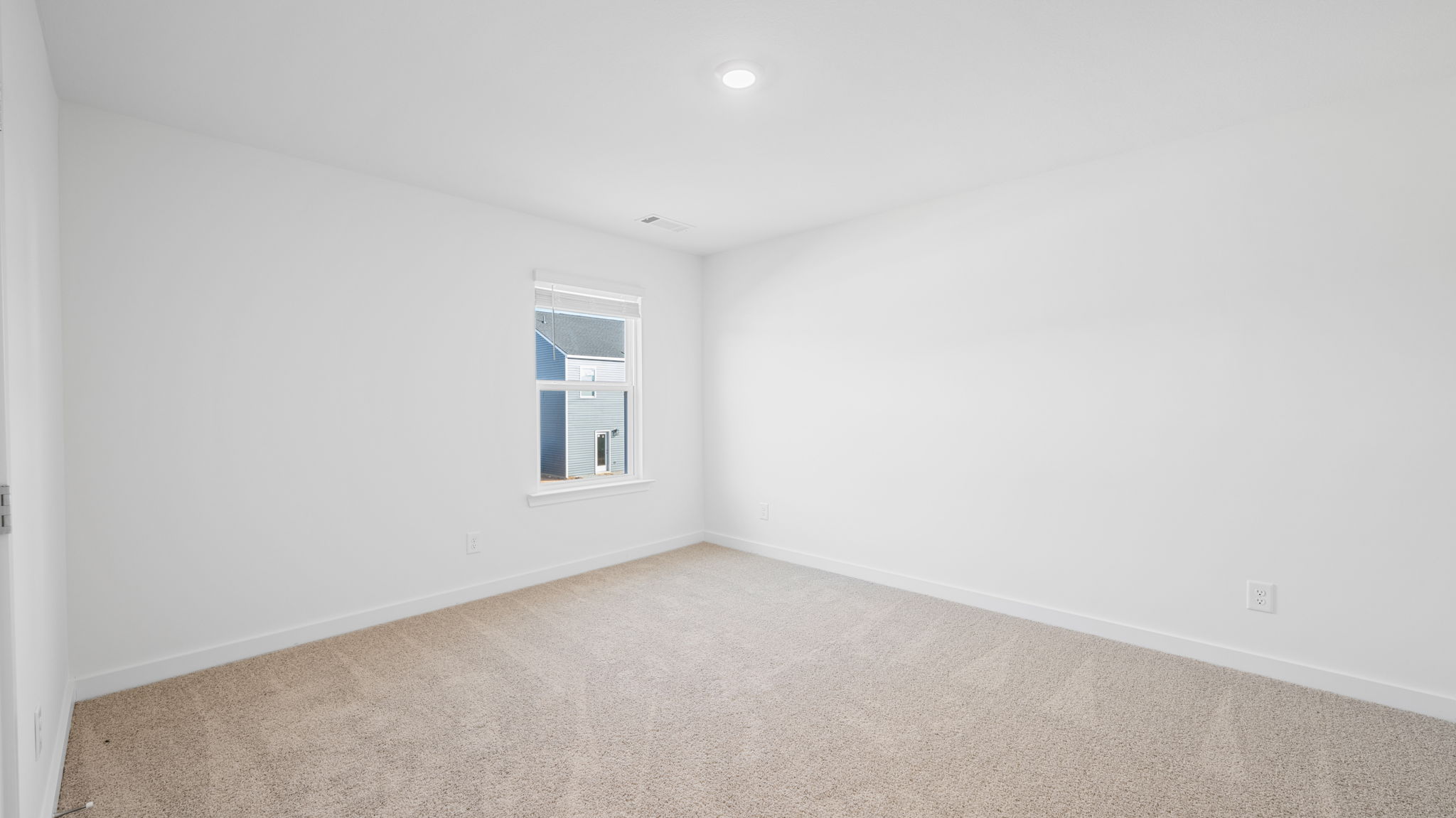 bedroom with single window and walk-in closet