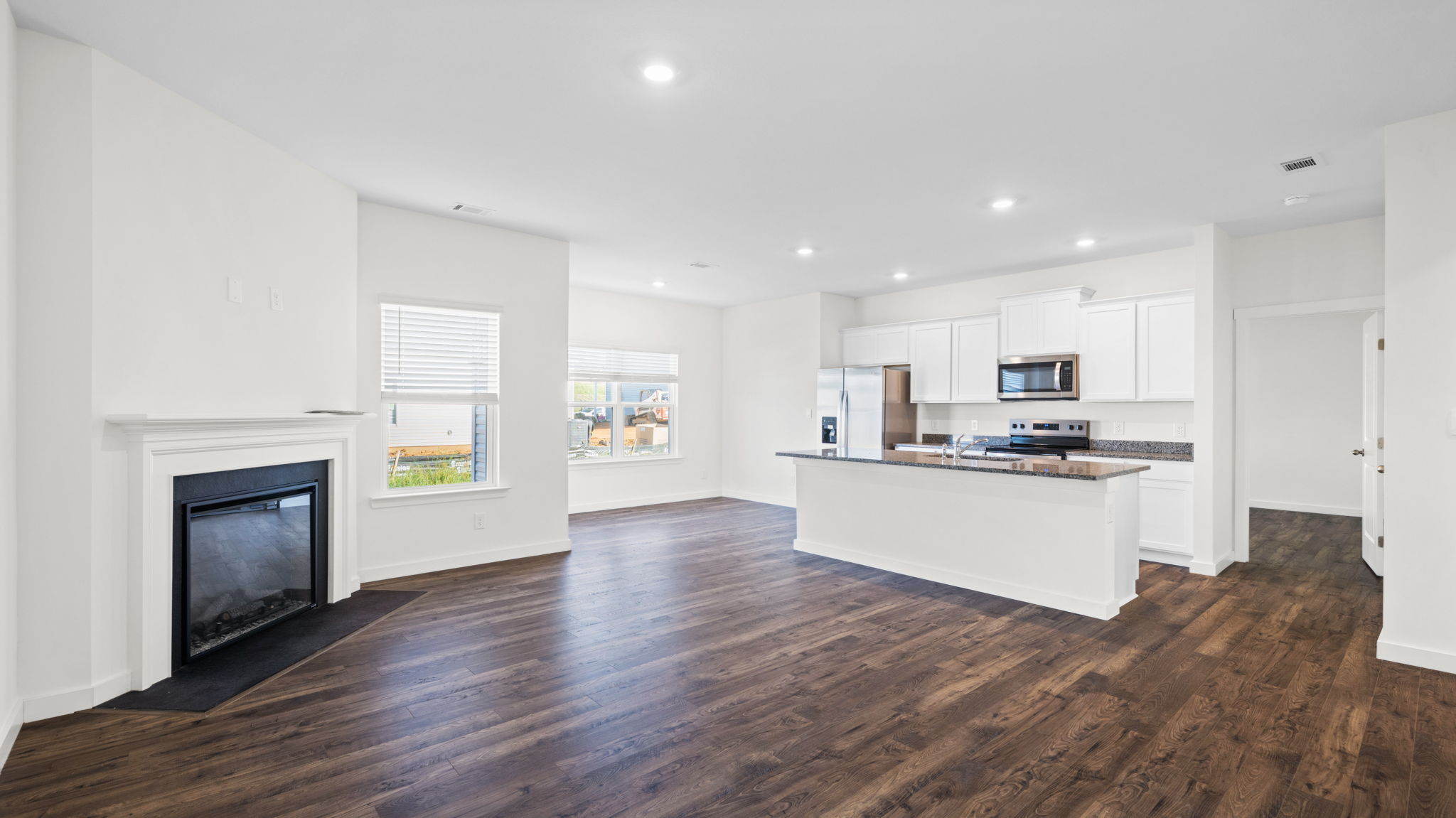 open concept living area with windows and fireplace