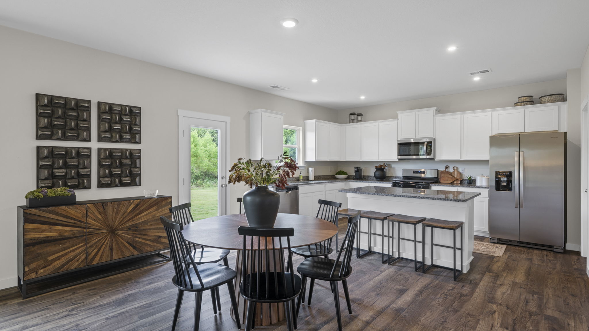open concept dining area with back patio door