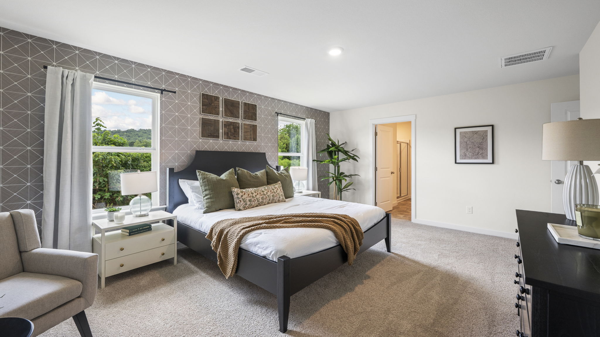 primary bedroom with two single windows and en suite