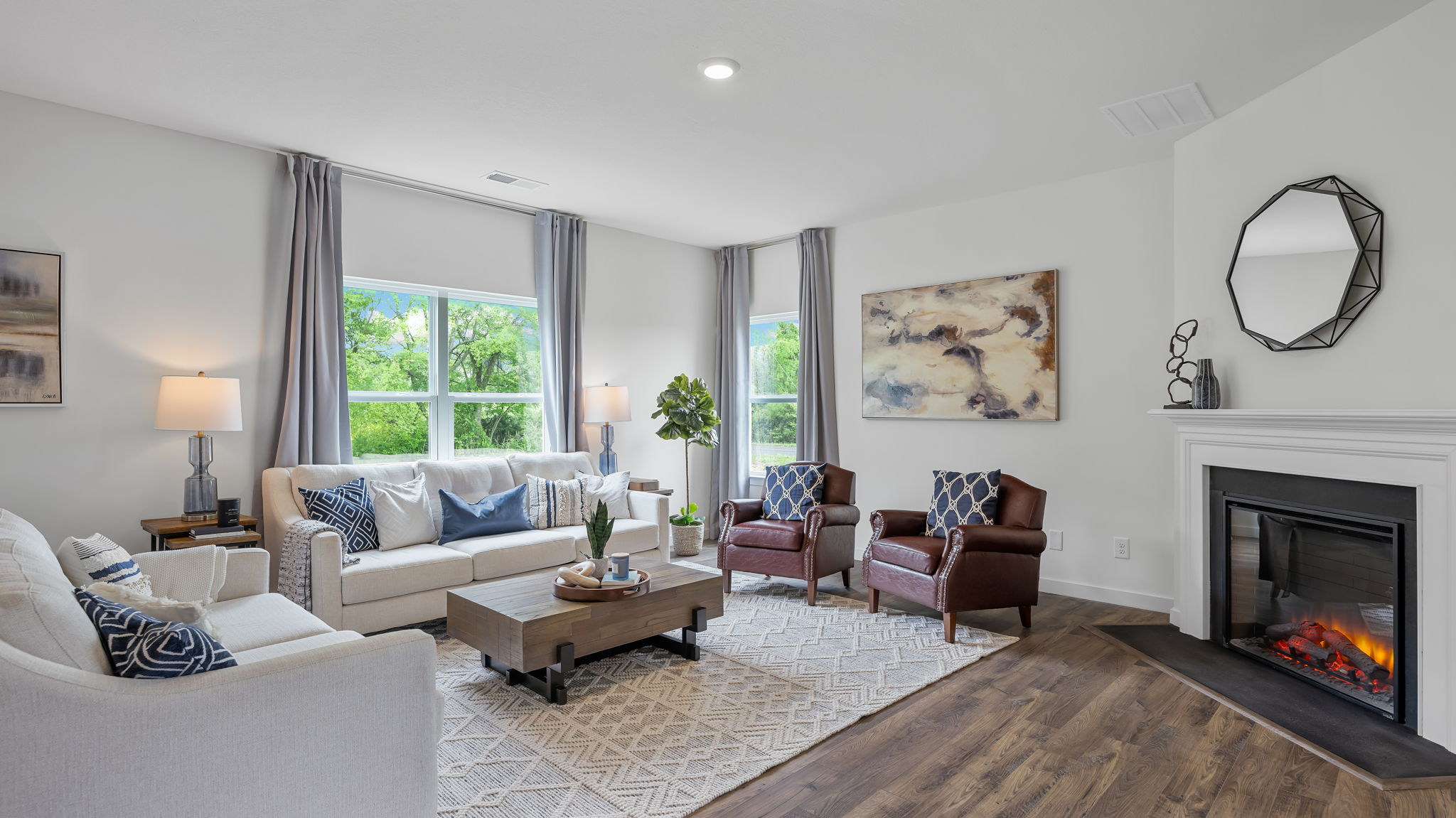 open concept living area with double and single window and fireplace