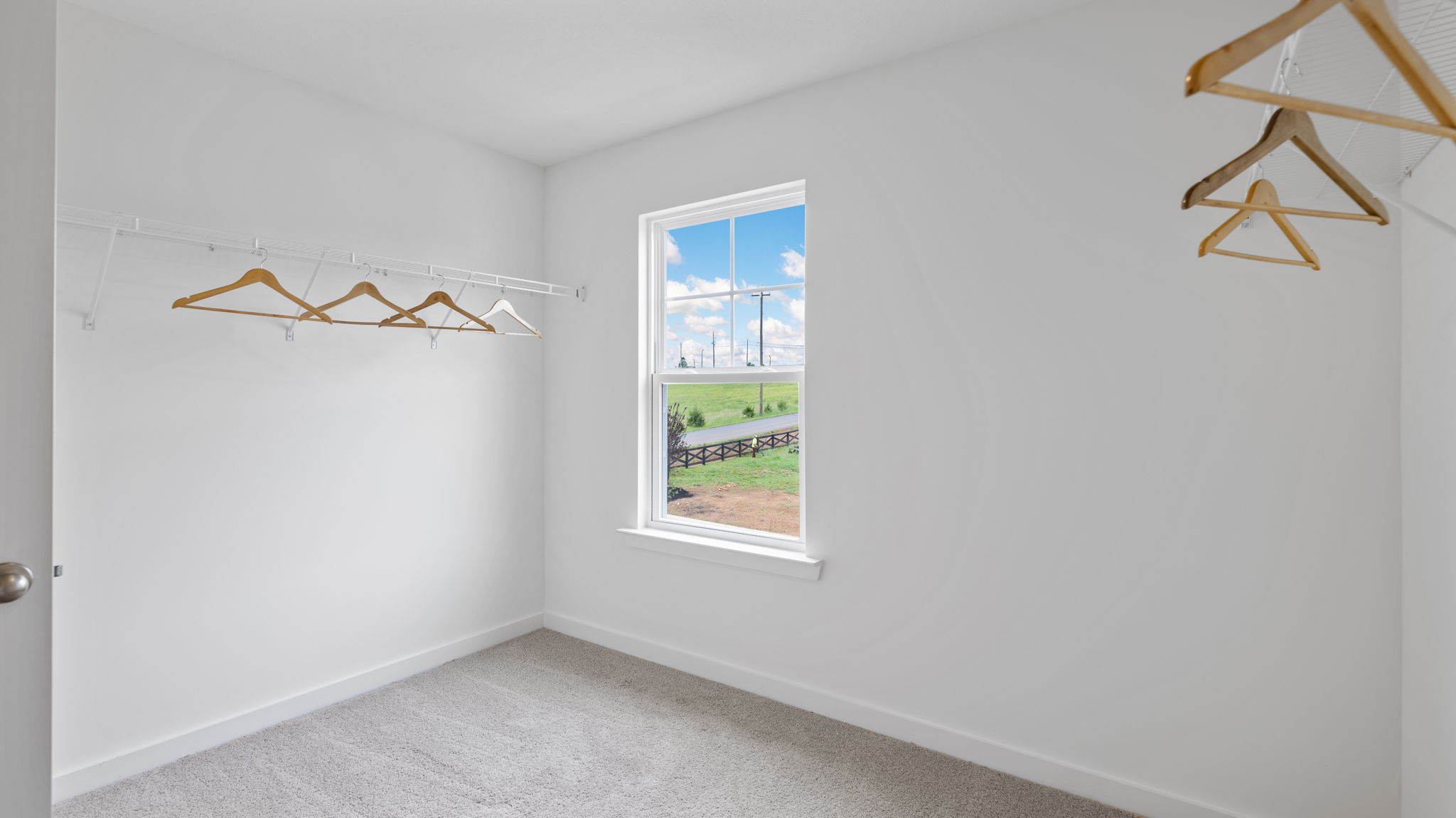 primary walk-in closet with window