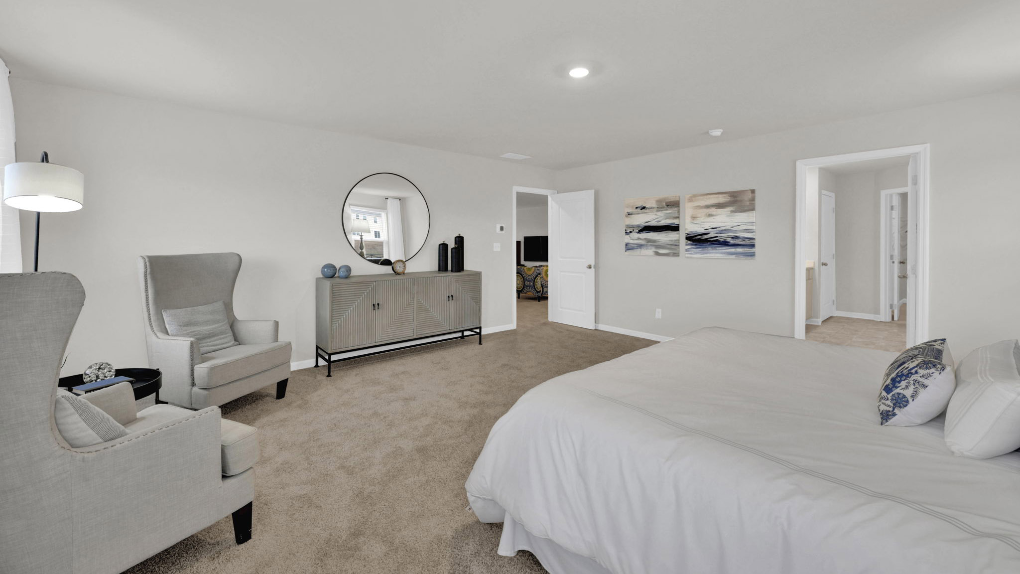 the primary bedroom is large enough for bed chairs and dresser