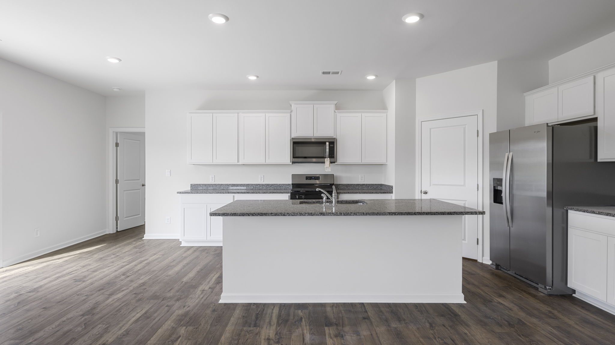 open concept kitchen with large island and walk-in pantry