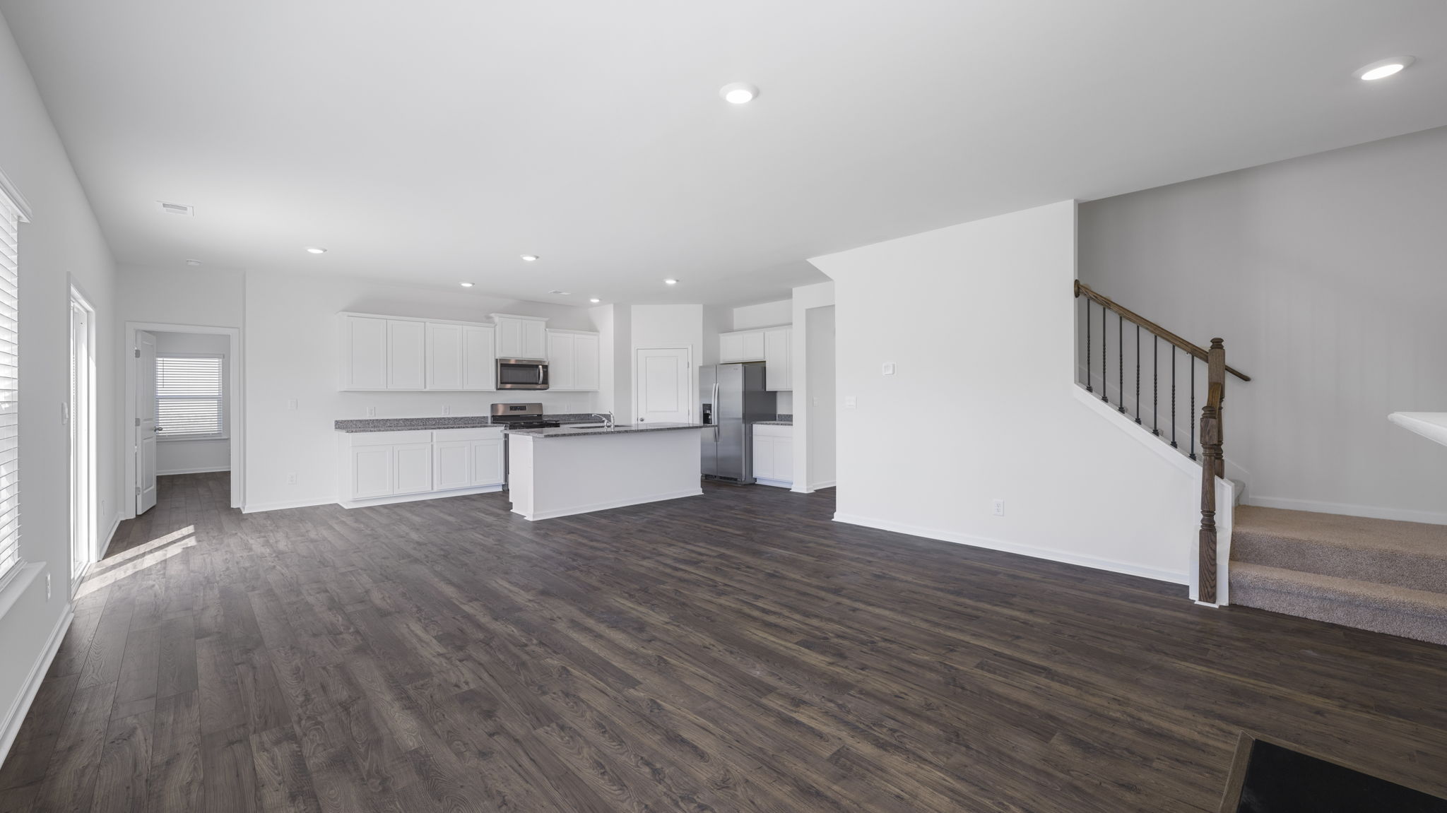 open concept living area with triple window and fireplace
