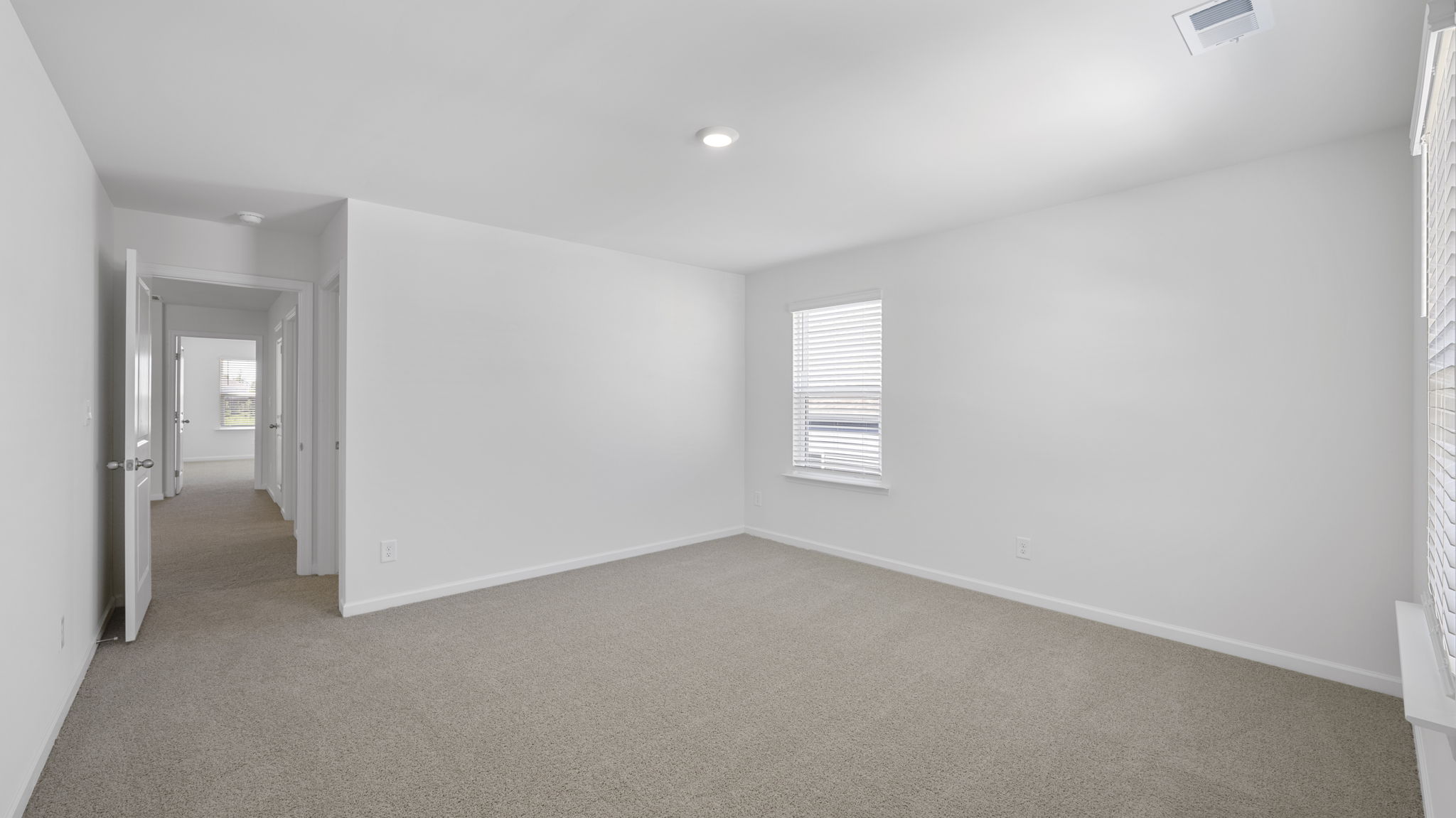 bedroom with two single windows and walk-in closet