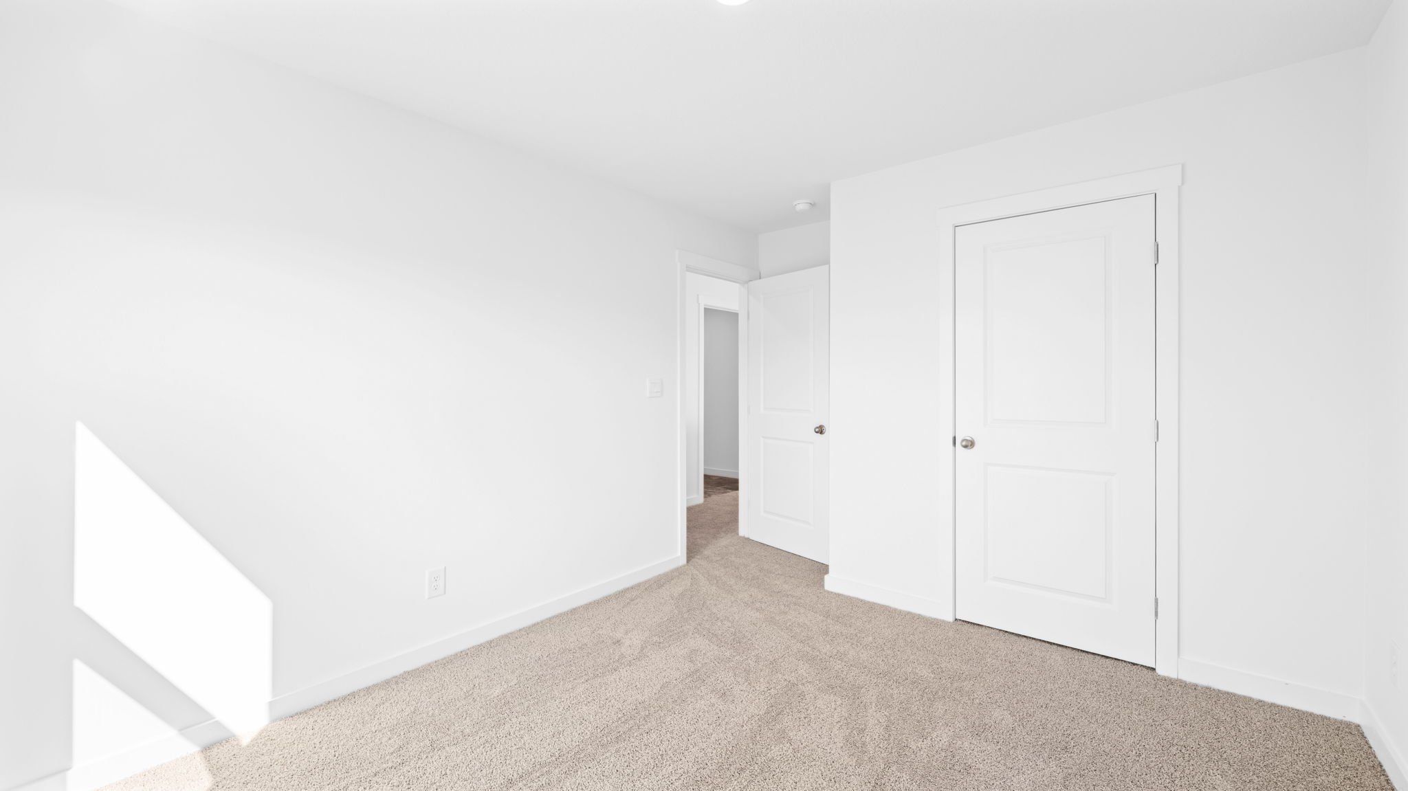 bedroom with carpet and open door way