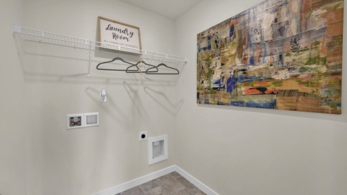 Laundry room on second floor with shelving