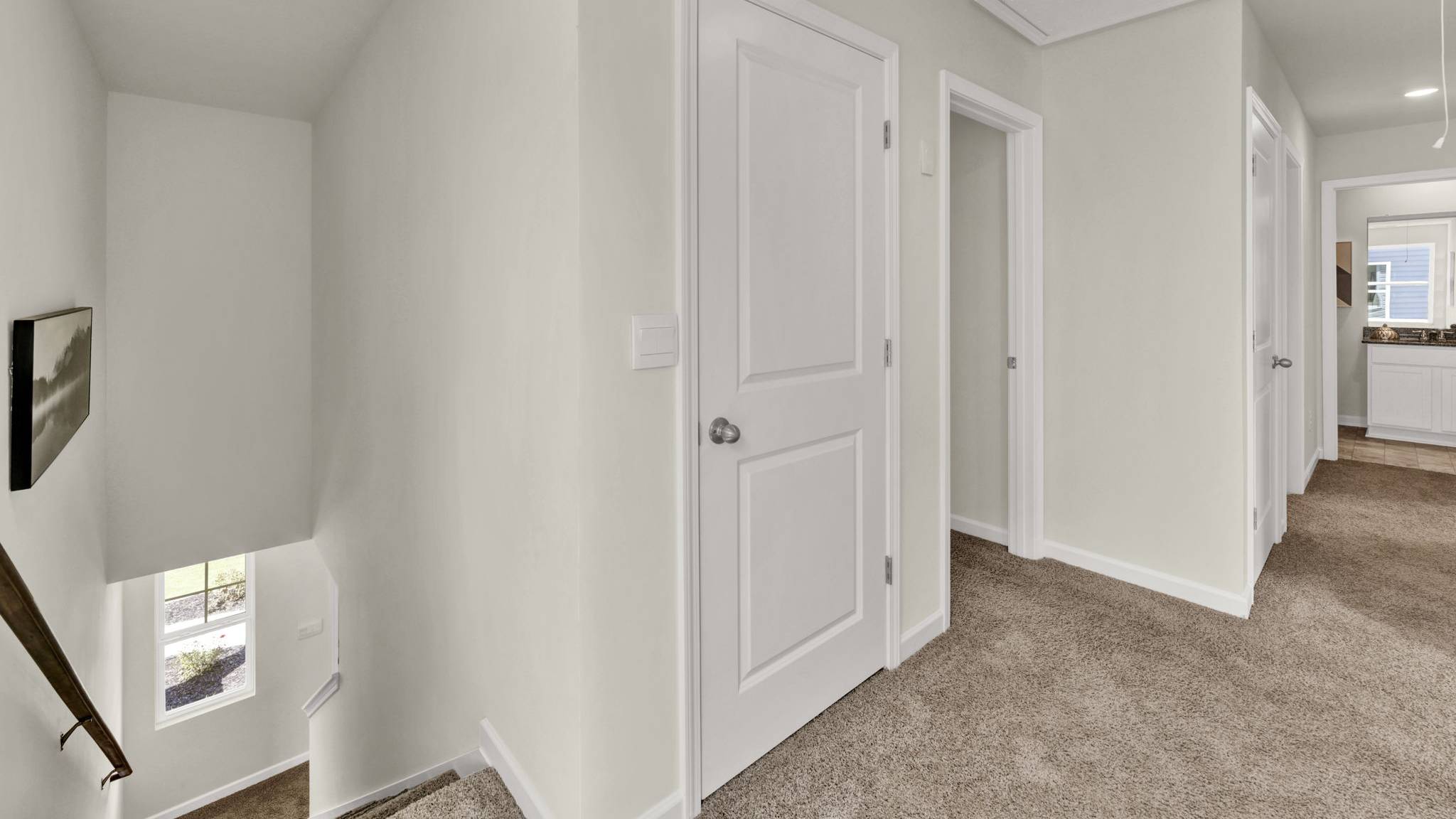 hallway with open doors and white walls