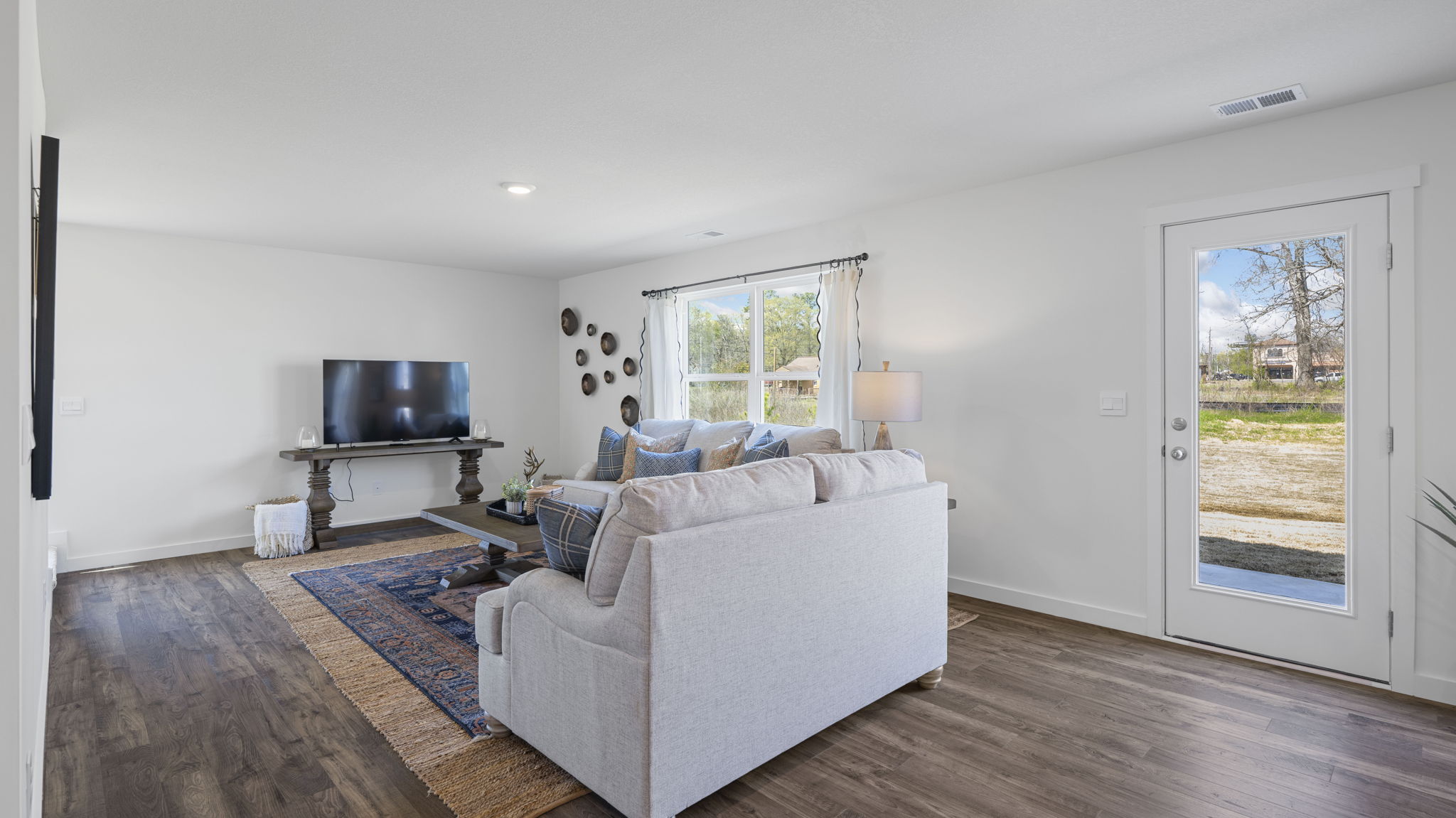 open concept living and dining with back patio door