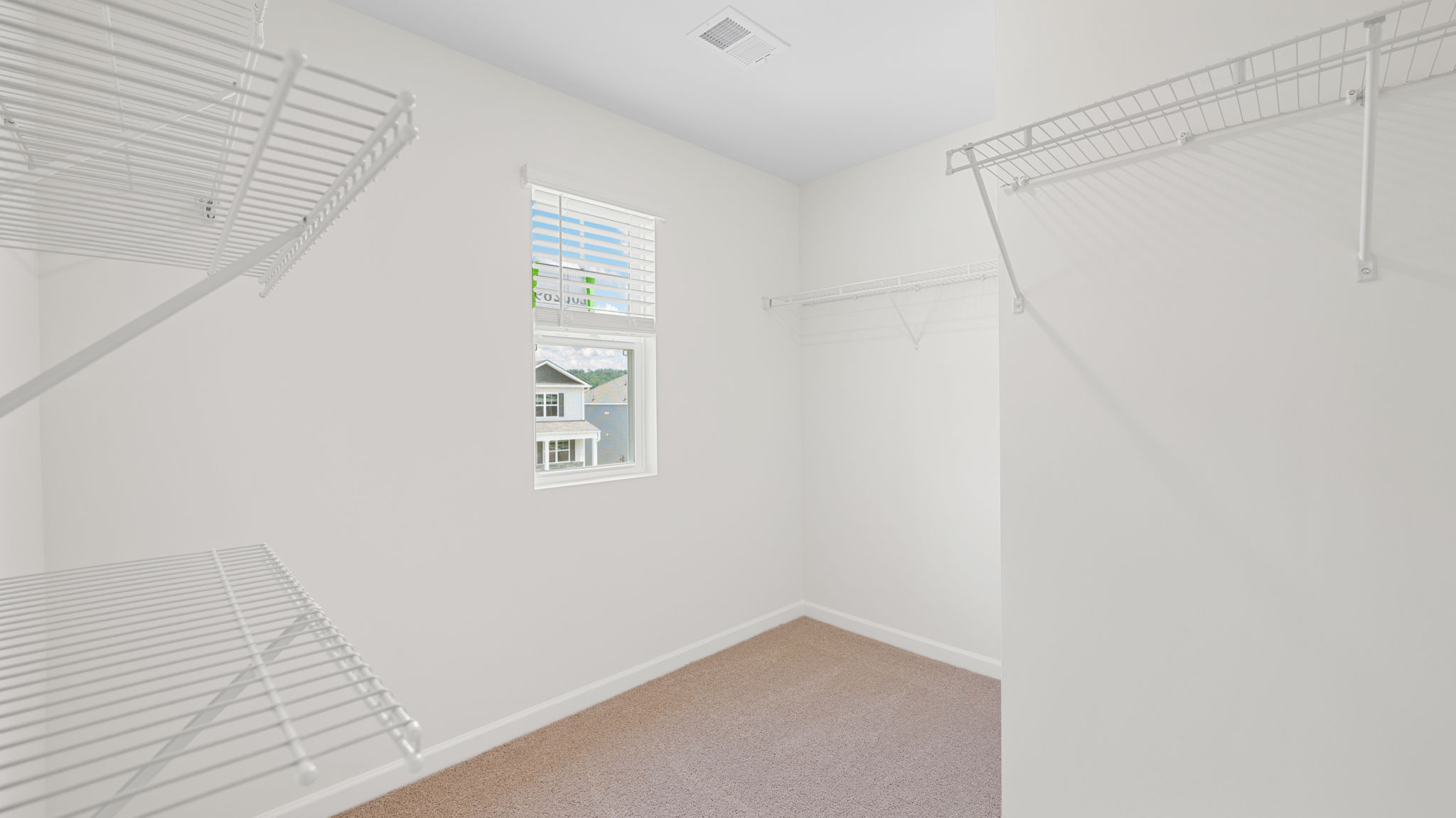 primary walk-in closet with window