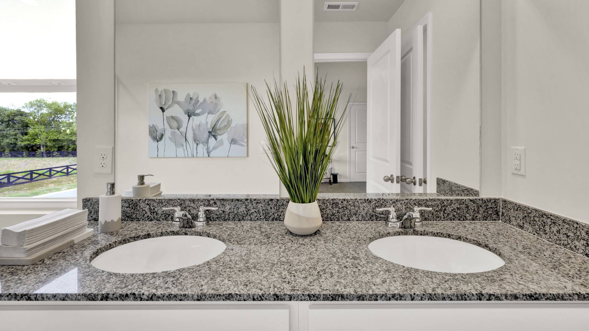 kitchen countertop with two sinks and mirror