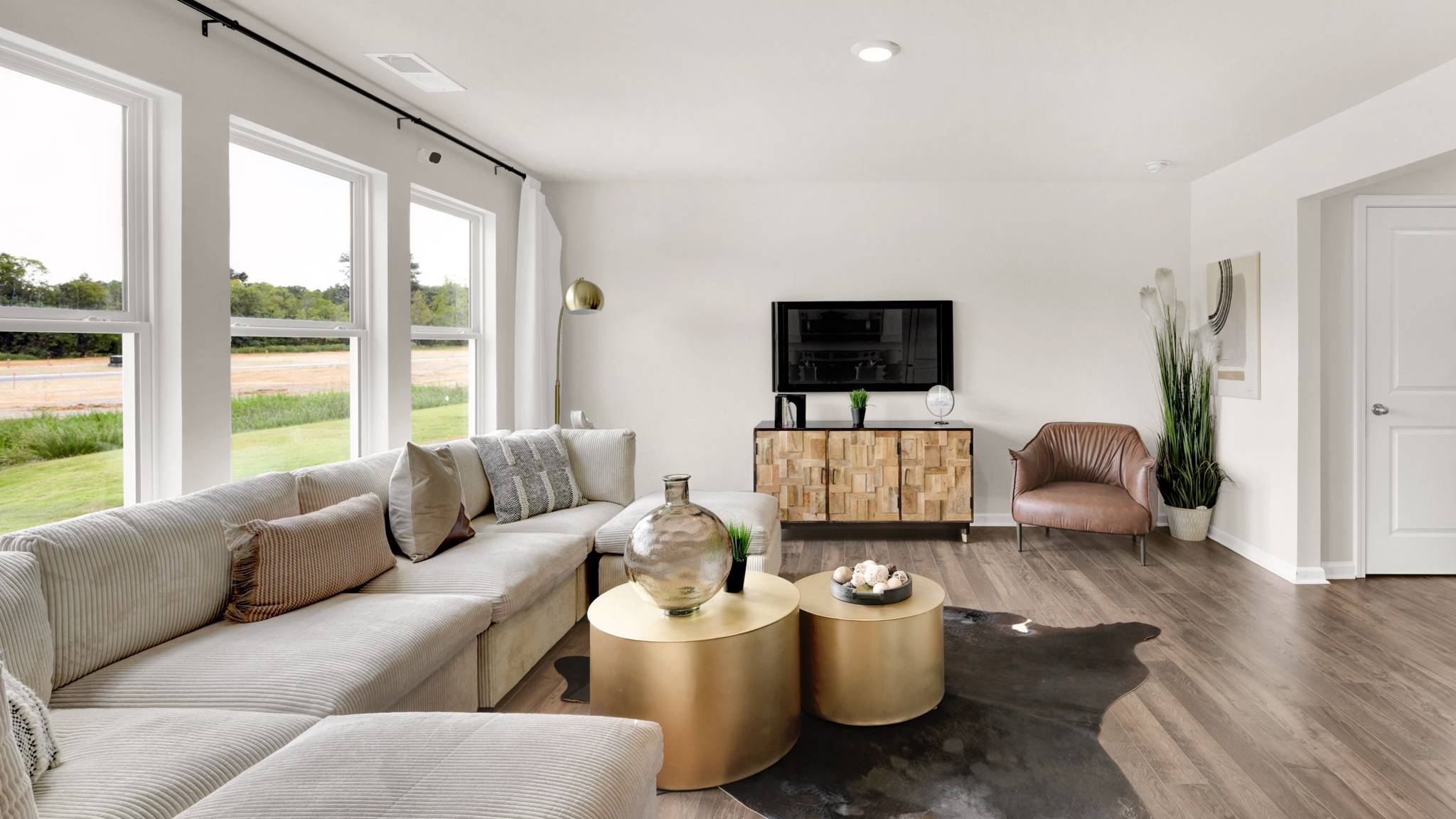 living area with television and exterior windows