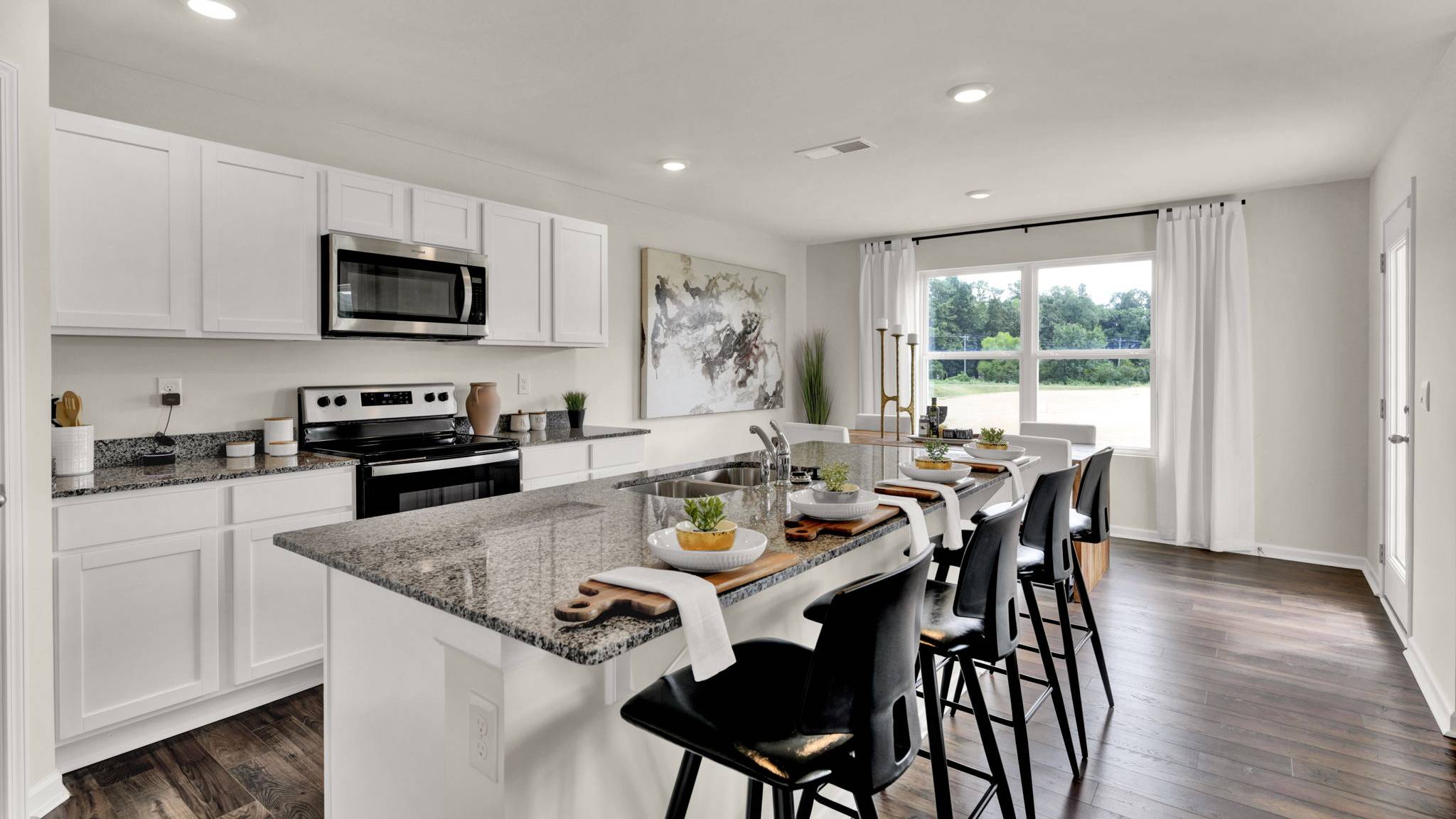side view of kitchen with island and chairs