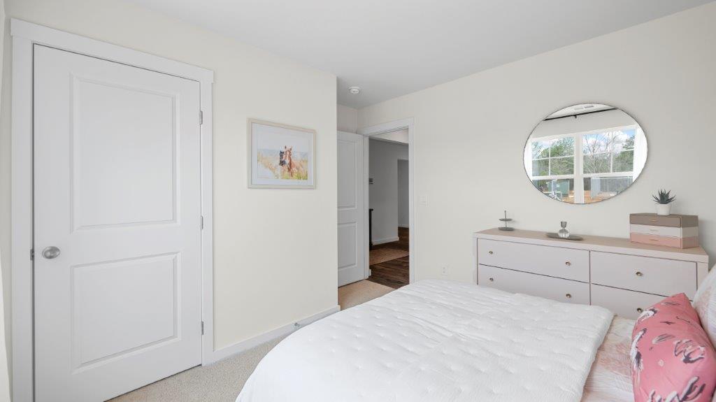 bedroom with double window and walk-in closet
