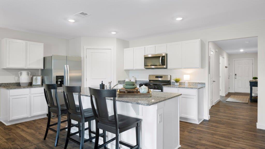 open concept kitchen with large island and stainless steel appliances