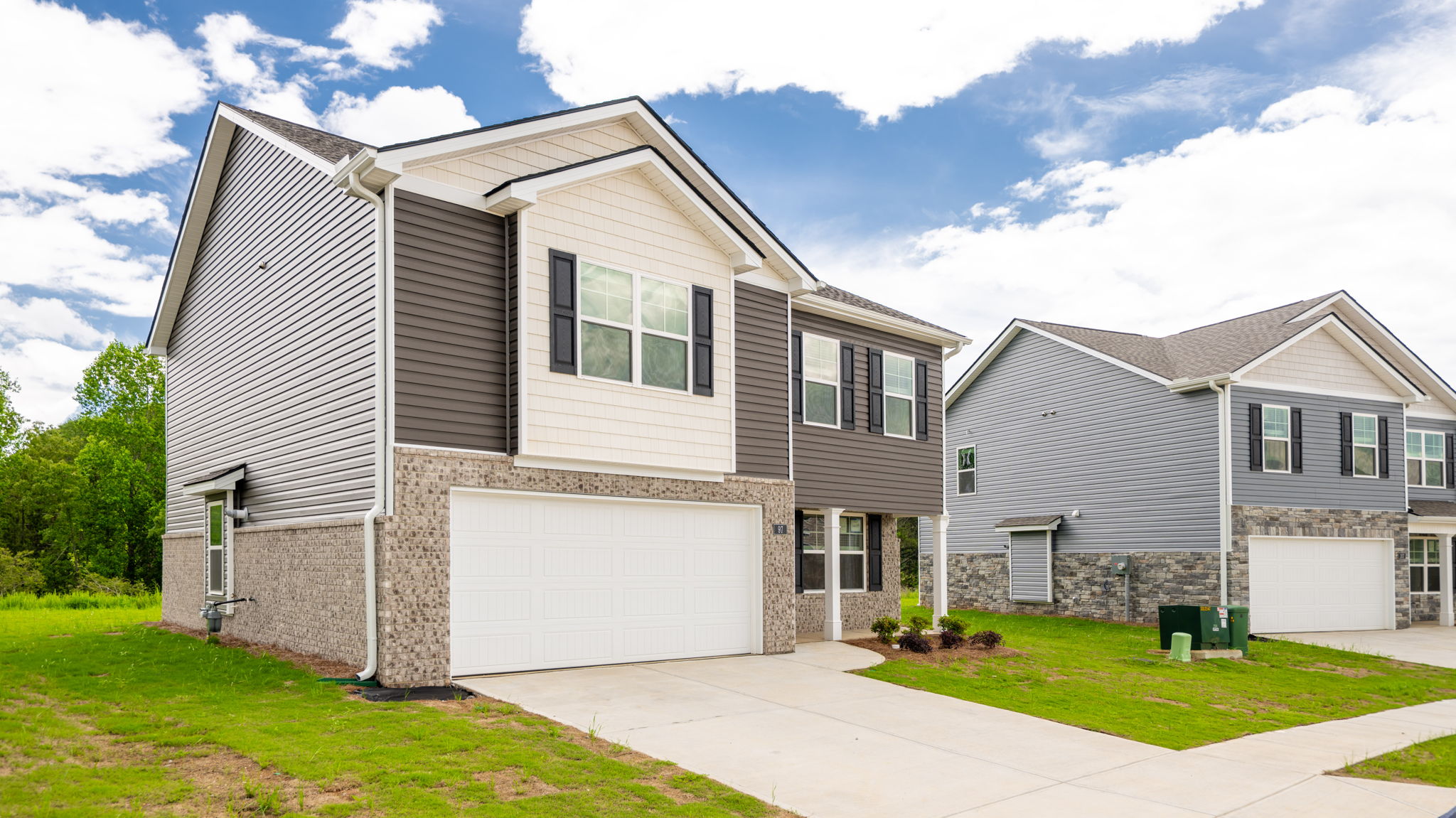 Two story home with two car garage and brick and vinyl
