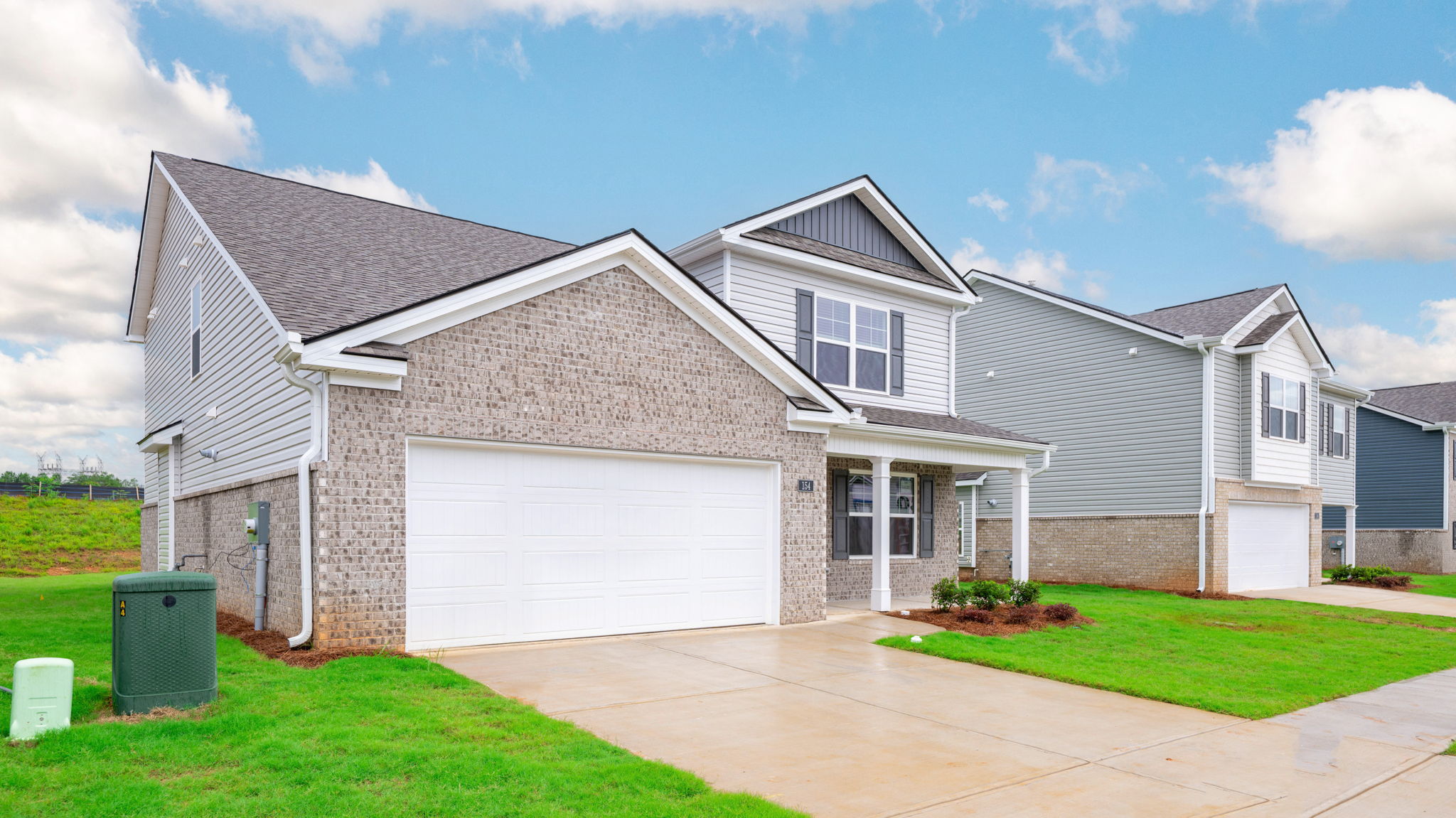 Exterior of two story home with garage and driveway.