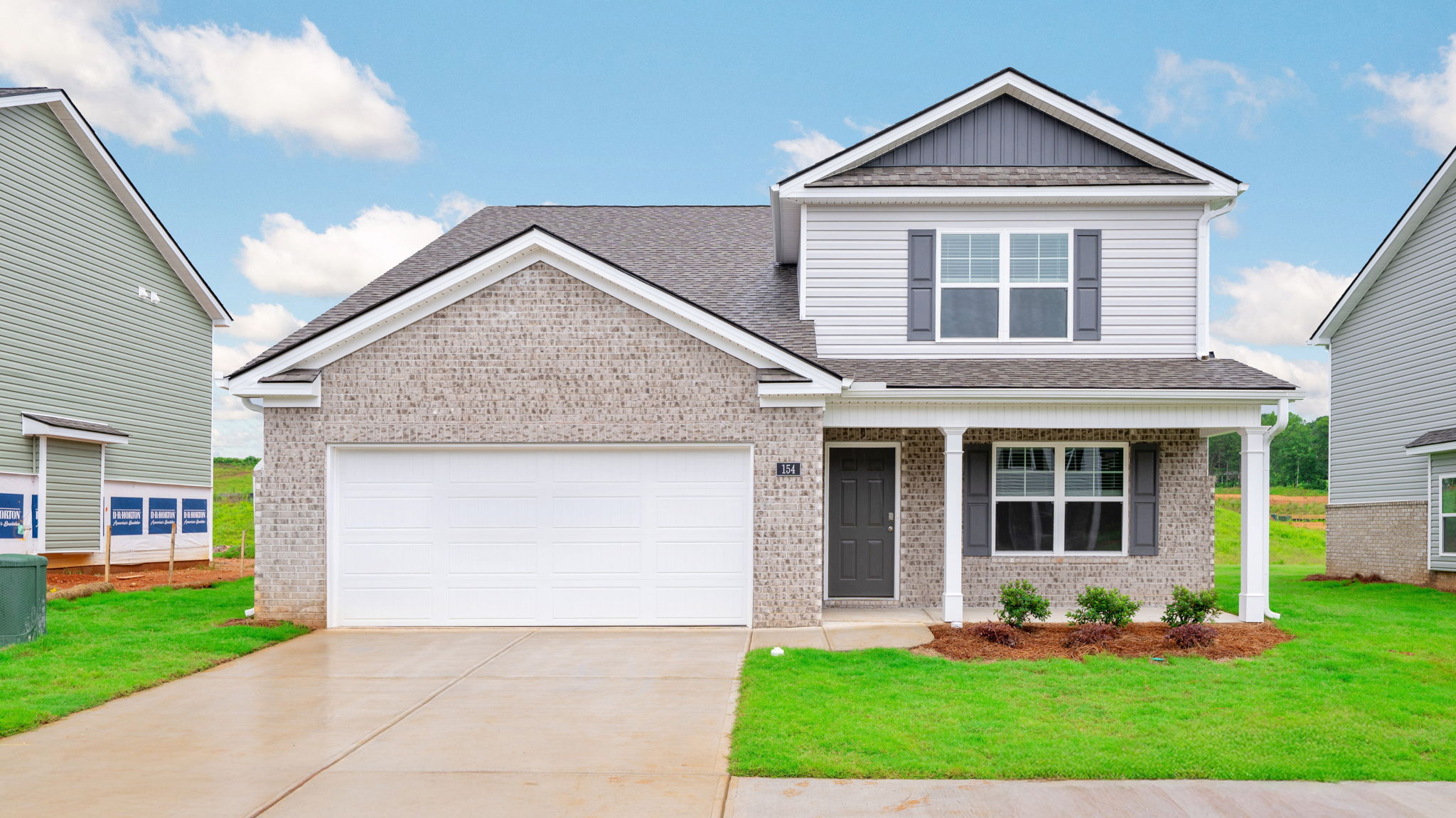 Exterior of two story home with garage and driveway.
