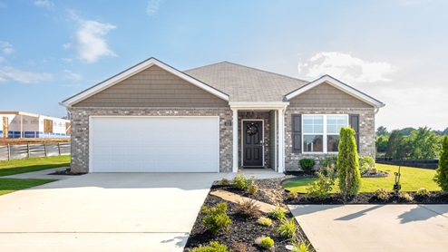 Exterior of one-story home with light brown brick