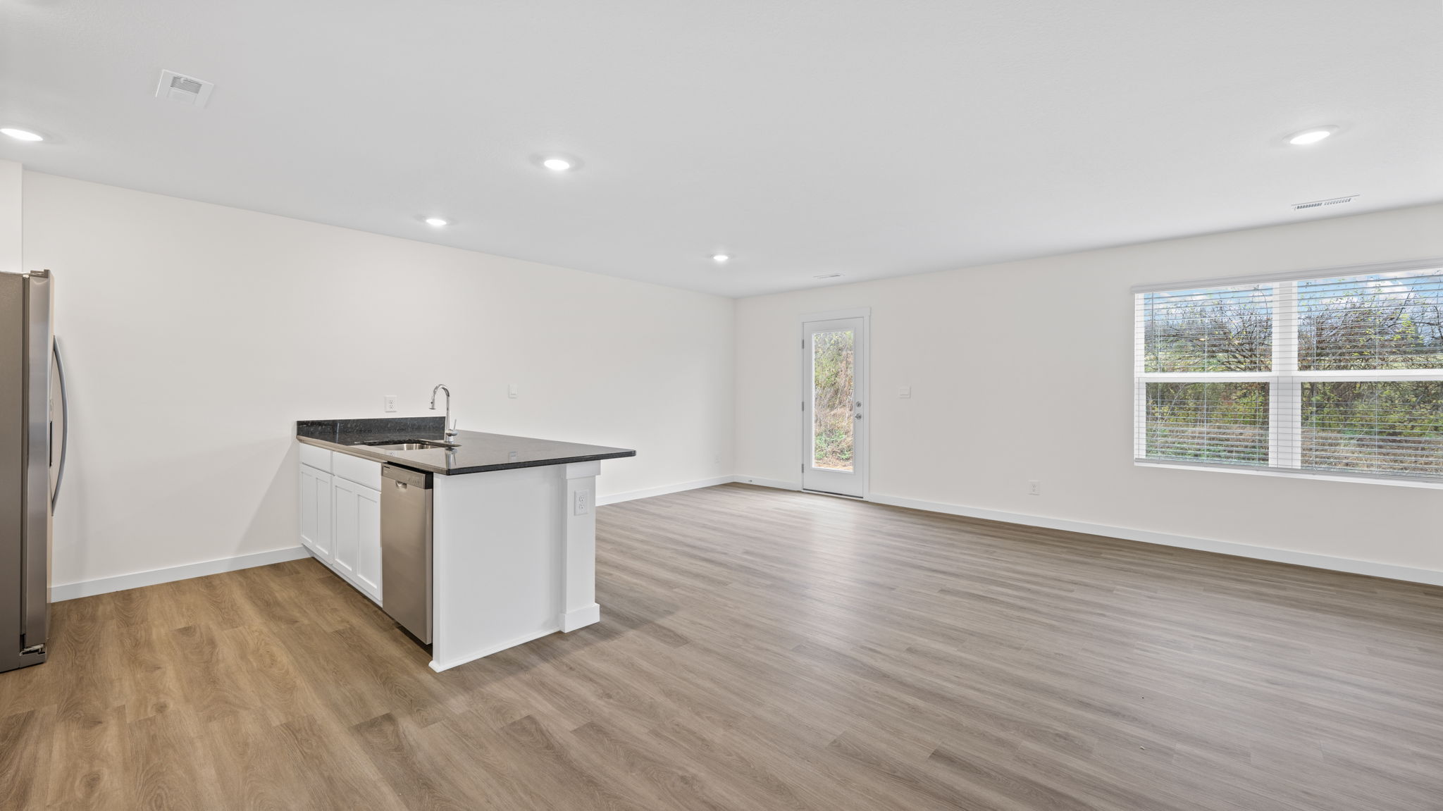 open concept living room and dining with double window