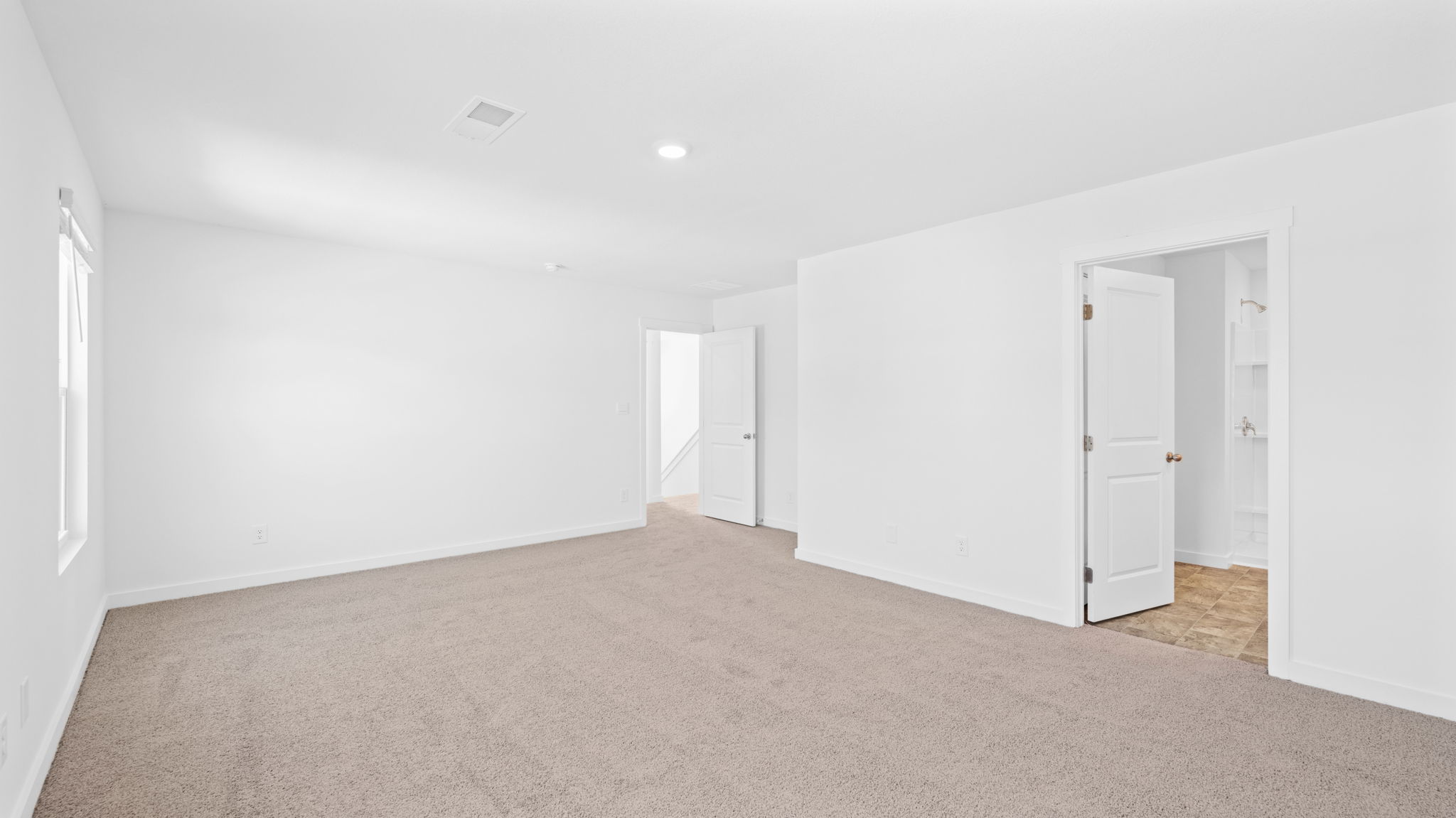 Primary bedroom designed with privacy and comfort in mind, flowing into our spa-inspired ensuite and walk-in closet Crescent Ridge