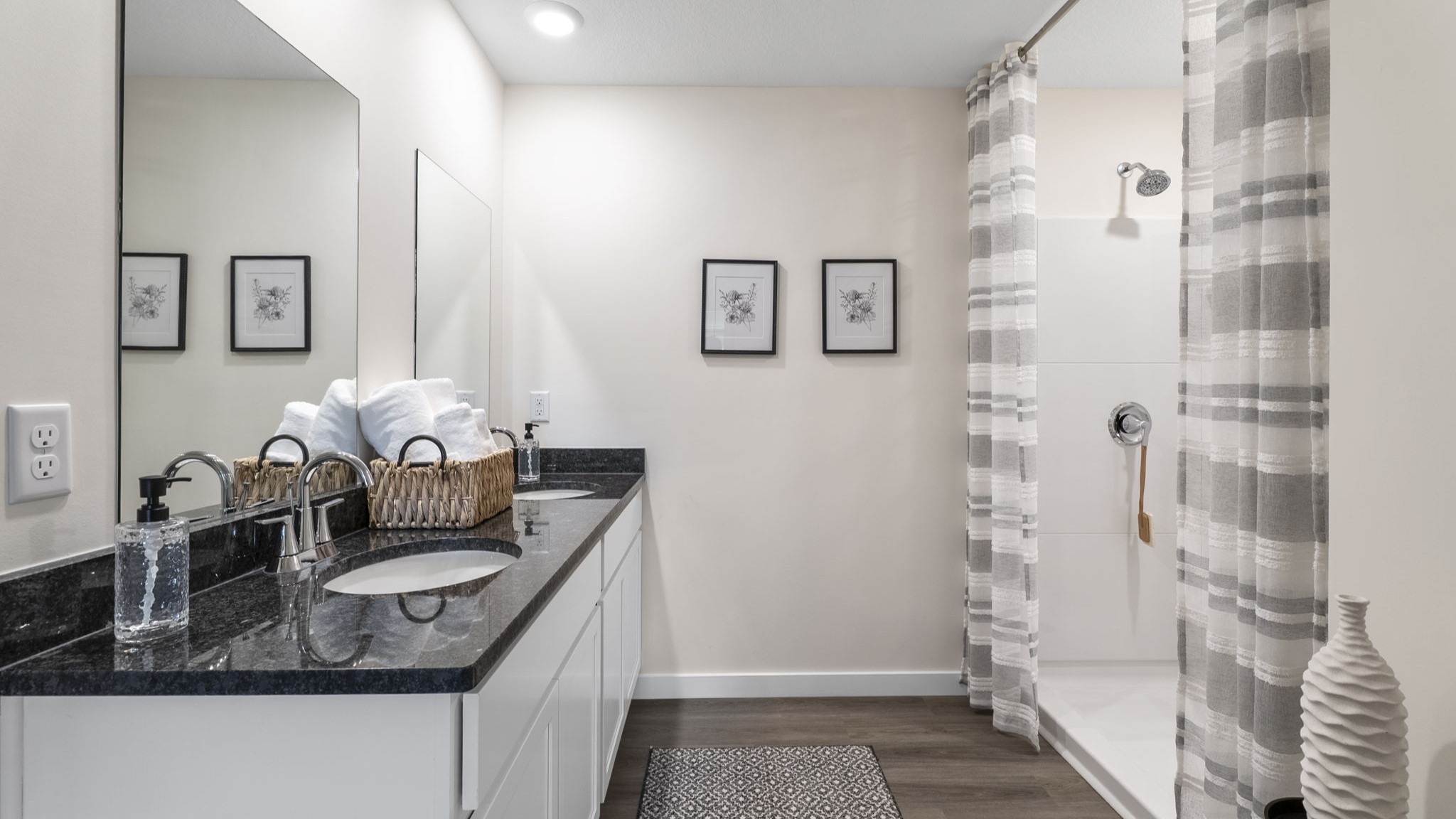 primary bathroom with double vanity and walk-in shower