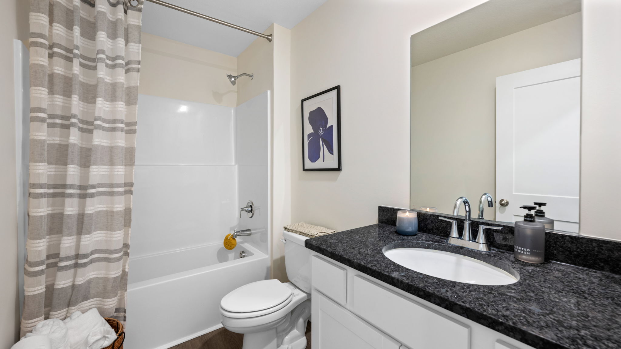 bathroom with single vanity and shower/ tub duo