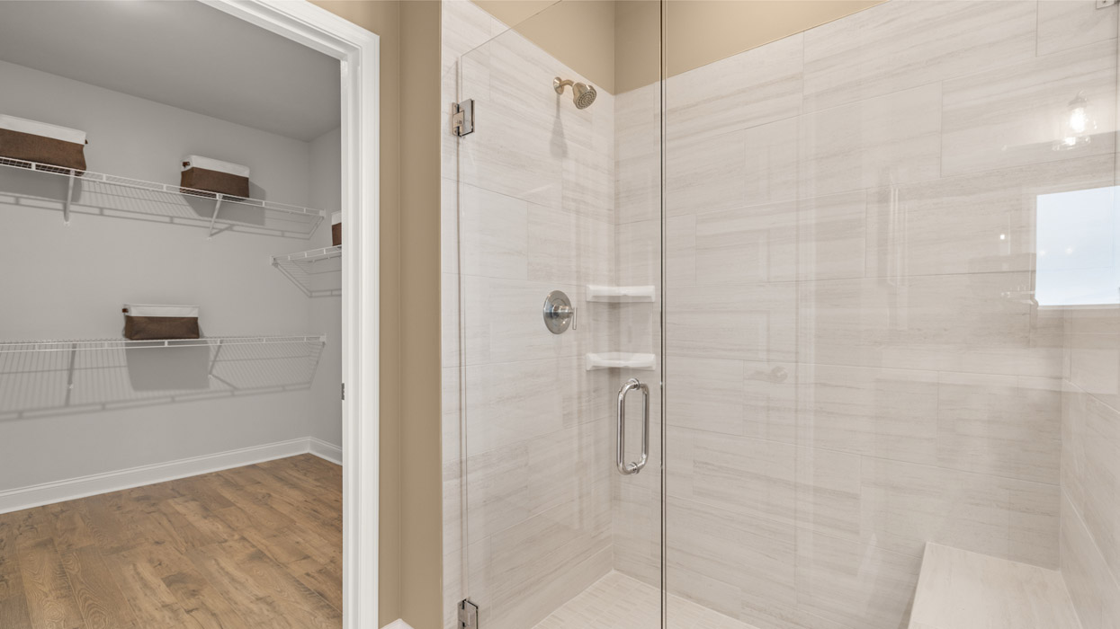 bathroom with shower and closet