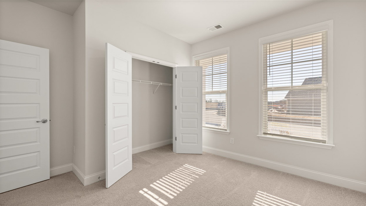 bedroom with two windows and closet