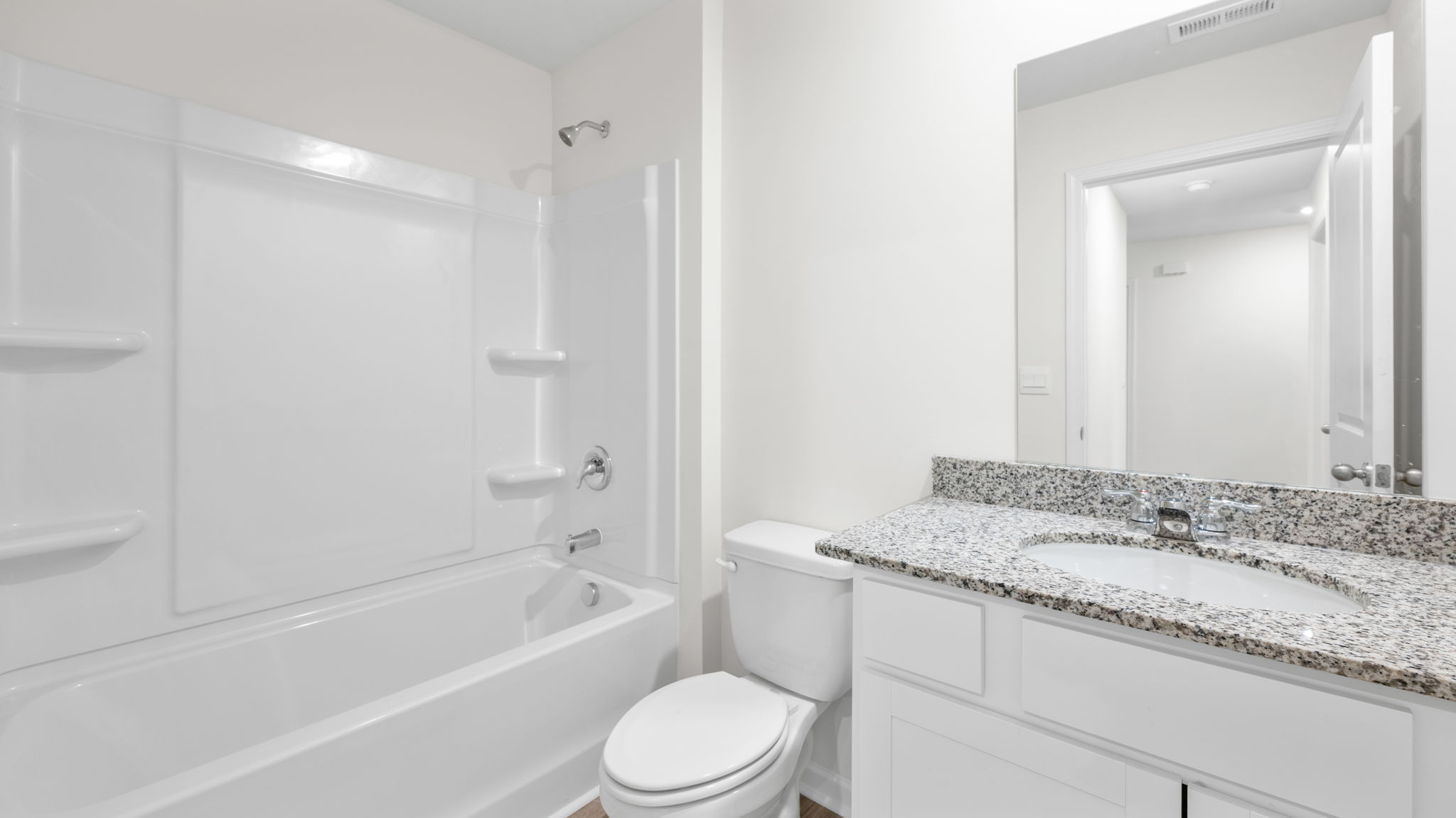 the bathroom has a sink and tub shower combination