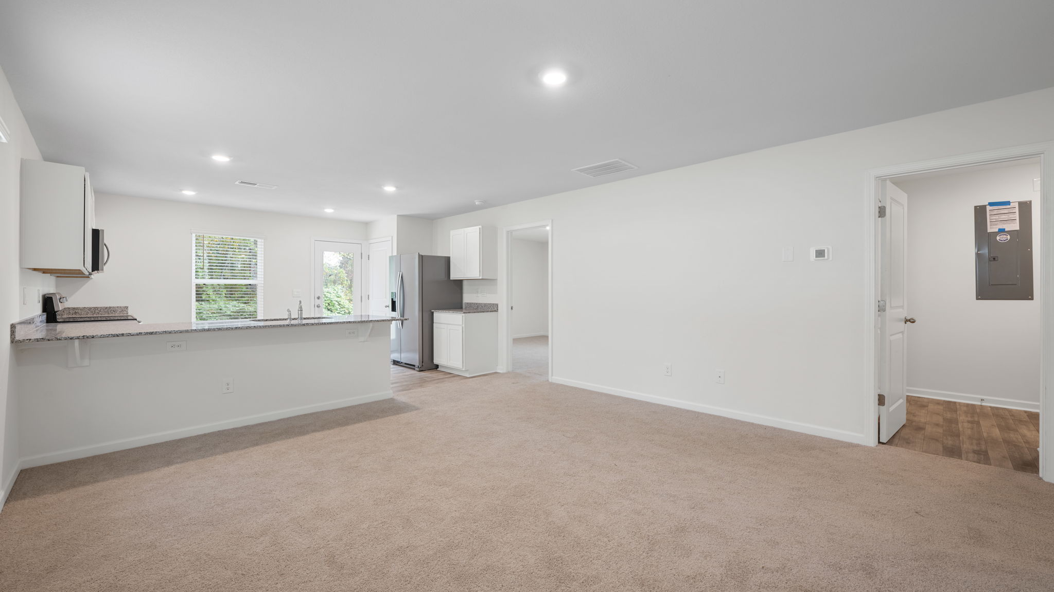open concept living room with two single windows