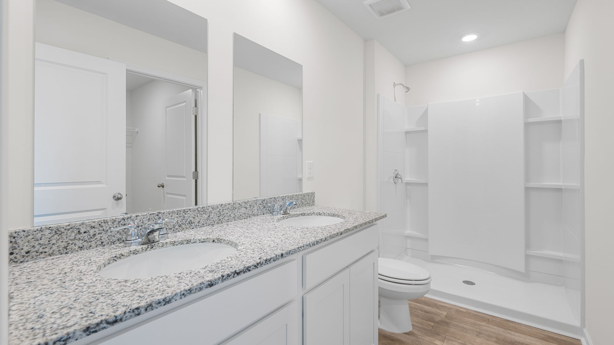 large bathroom countertops with two sinks and shower
